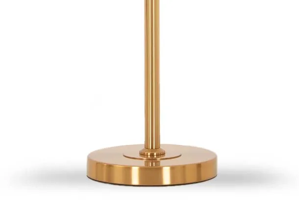 A gold arc metal table lamp from EZ Livings Casper range. Closeup of round disc stand