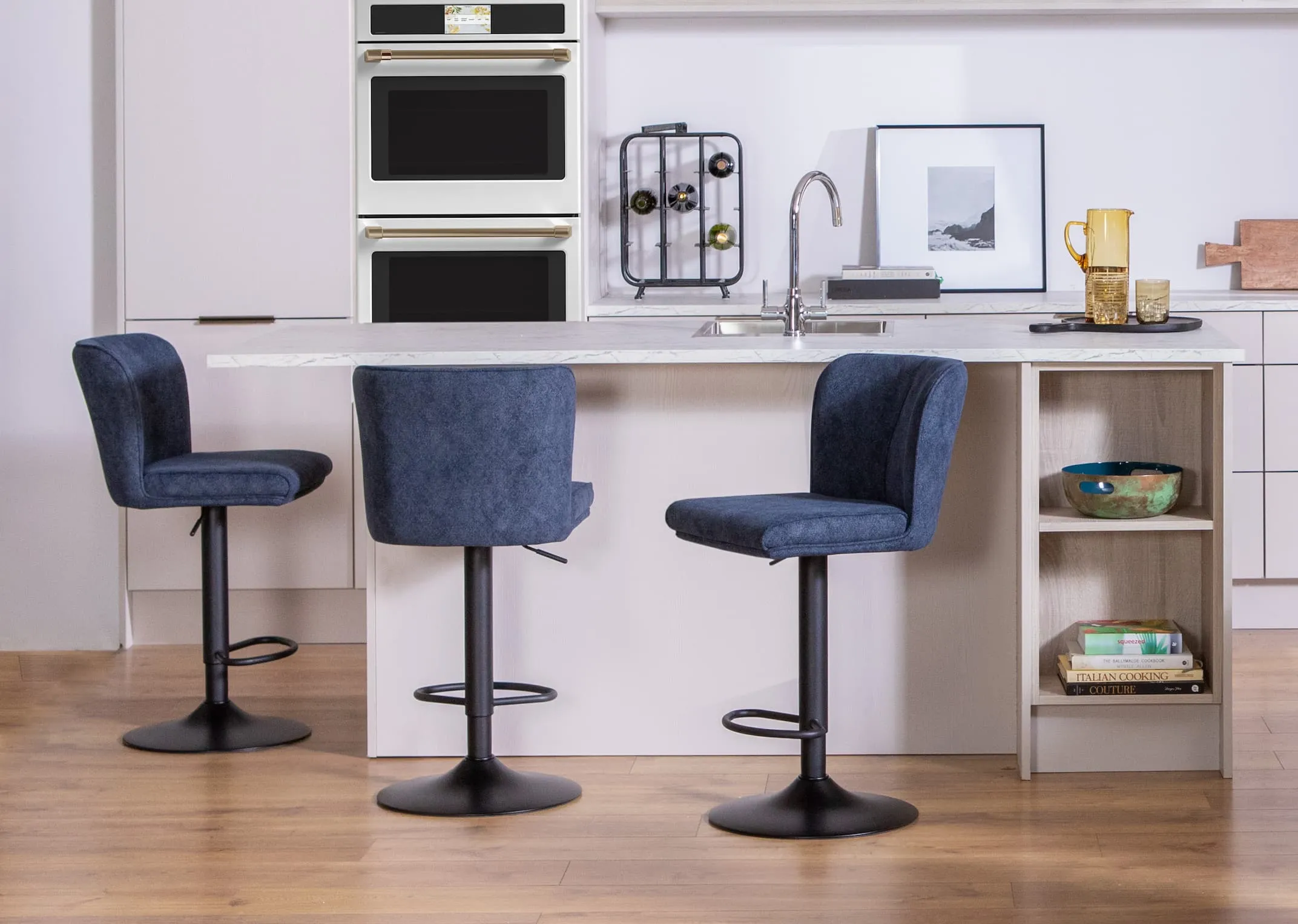 A lifestyle image of three Maple blue barstools at an island in a kichen setting.