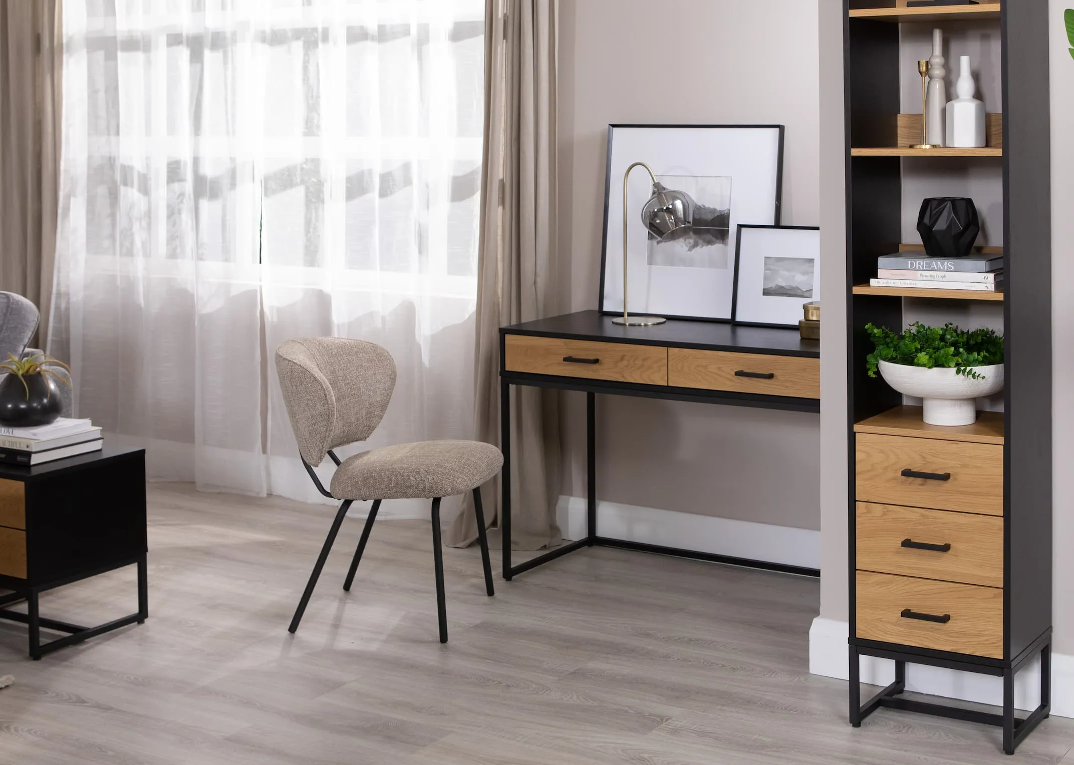 A lifestyle image of the Camilia beige chair with the Amsterdam desk with matching 3 drawer shevling unit