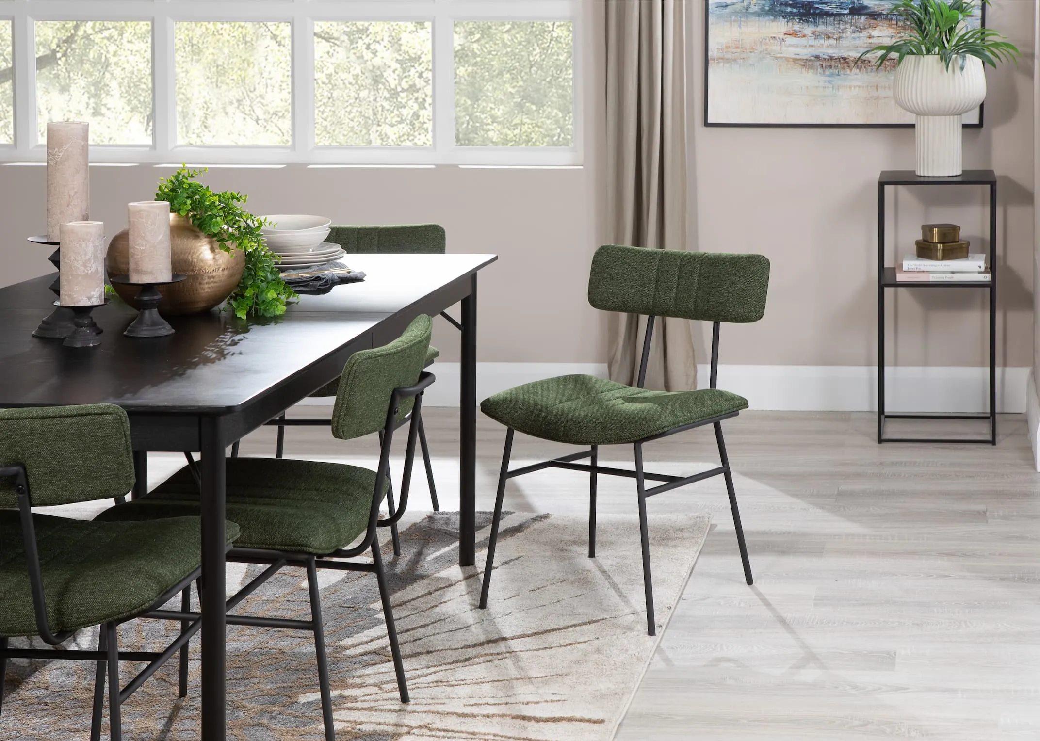 A lifestyle image of the Savona rectangular table with Decker green fabric chairs and pasha rug with pebble plant stand