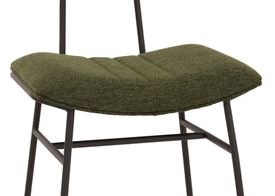 A metal frame dining chair with green fabric seat and slim back from EZ Livings Decker range. Closeup of arched seat