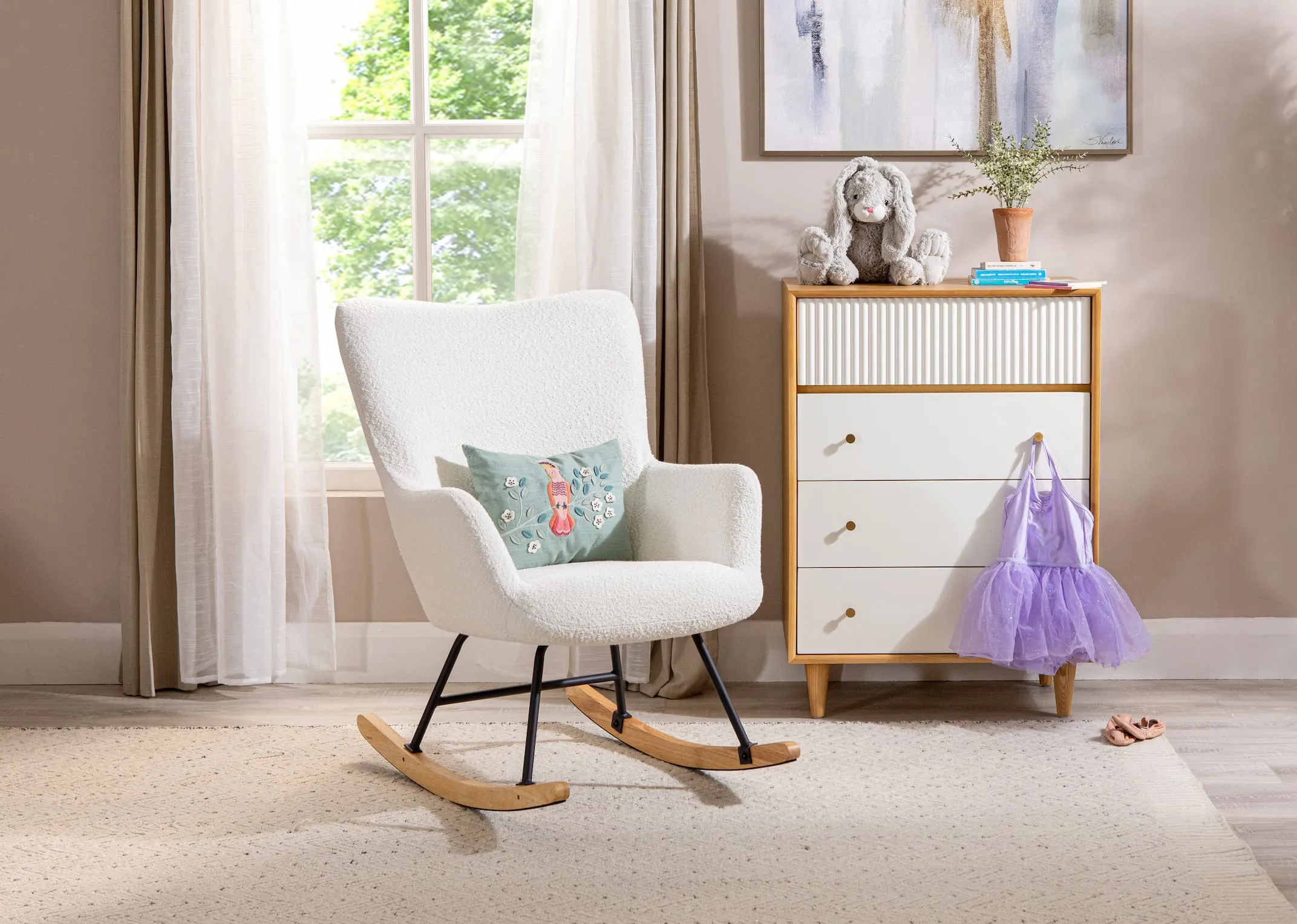A lifestyle image of the Percy Rocking chair with the Lolas chest of drawers in a childs room with a bunny and ballerina set