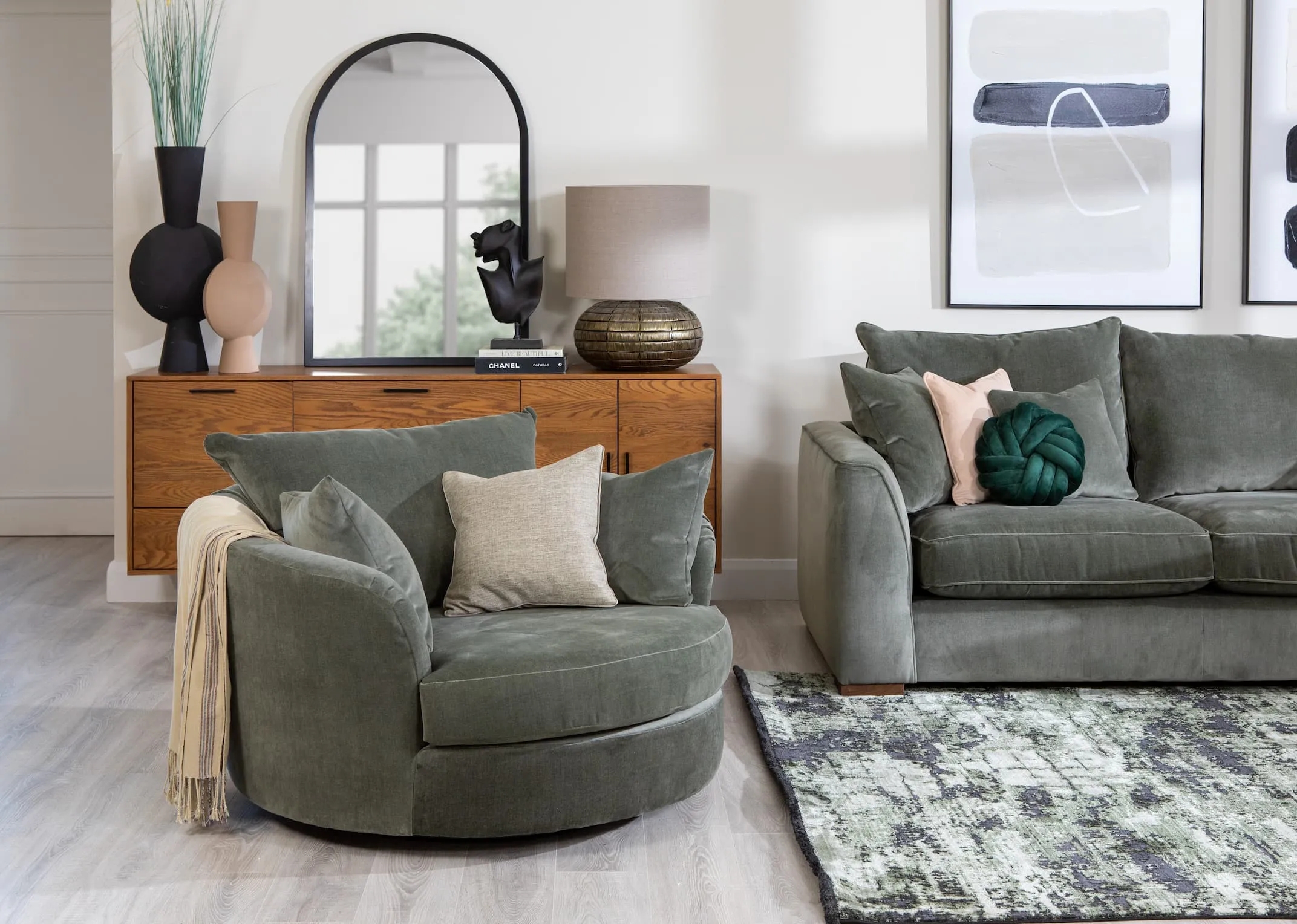 A lifestyle image of the Lucius Swivel Cuddler with Corner Group and Rima rug.