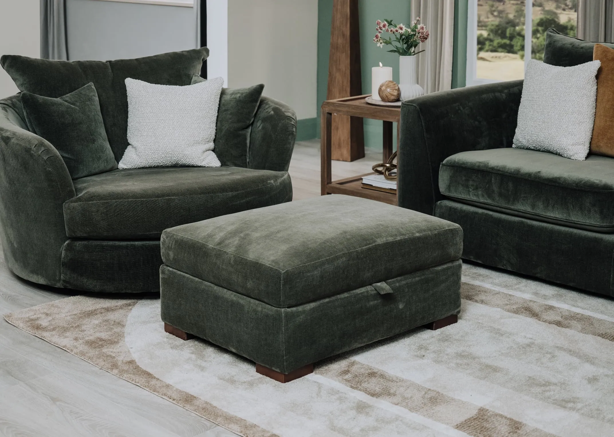 A lifestyle image of the Lucius swivel & footstool with Knitted cushion and delilah rug.