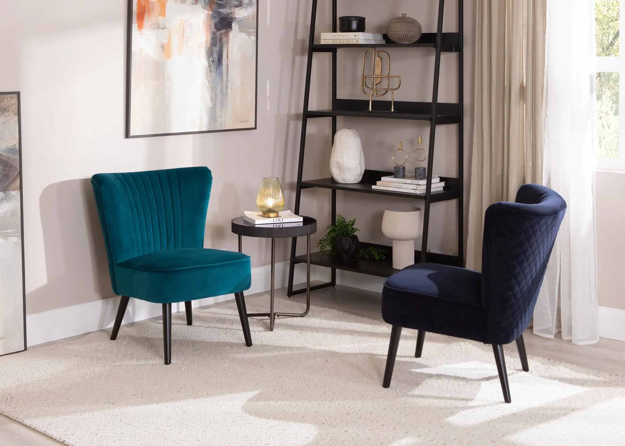 A lifetsyle image of the Sakura lounge chair in teal and in navy with the mandy side table & book display unit.