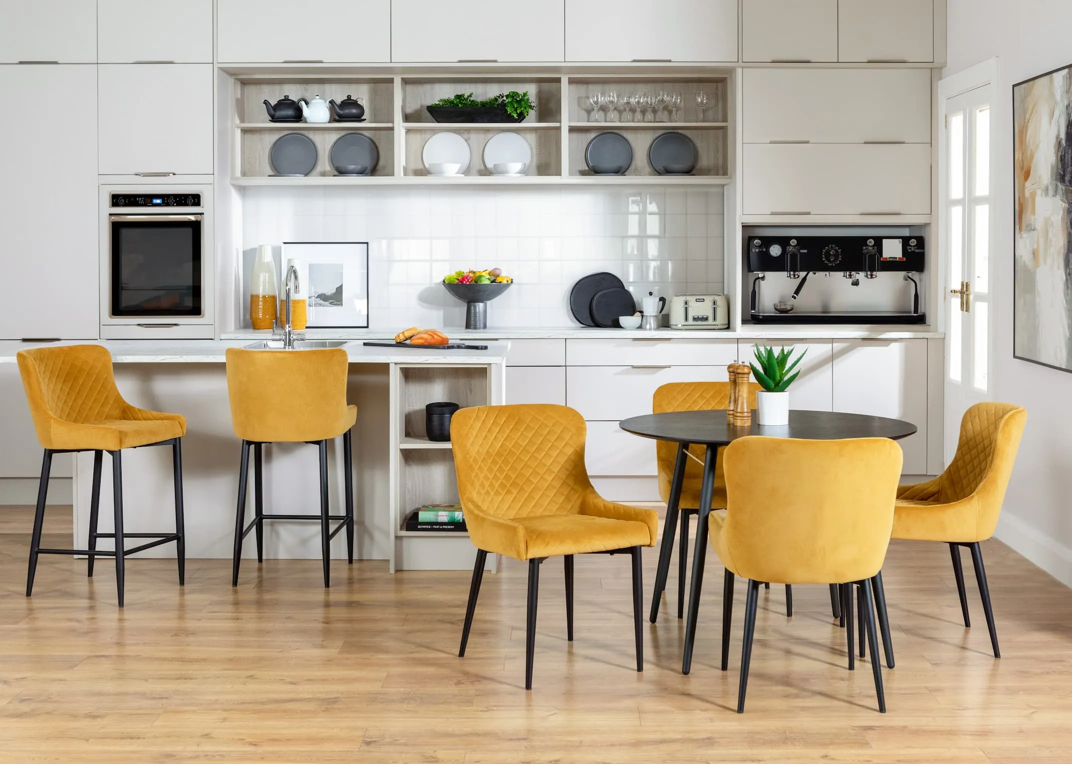 A lifestyle image of the Ottowa Dining chairs and stools with Lux table in a modern kitchen setting.