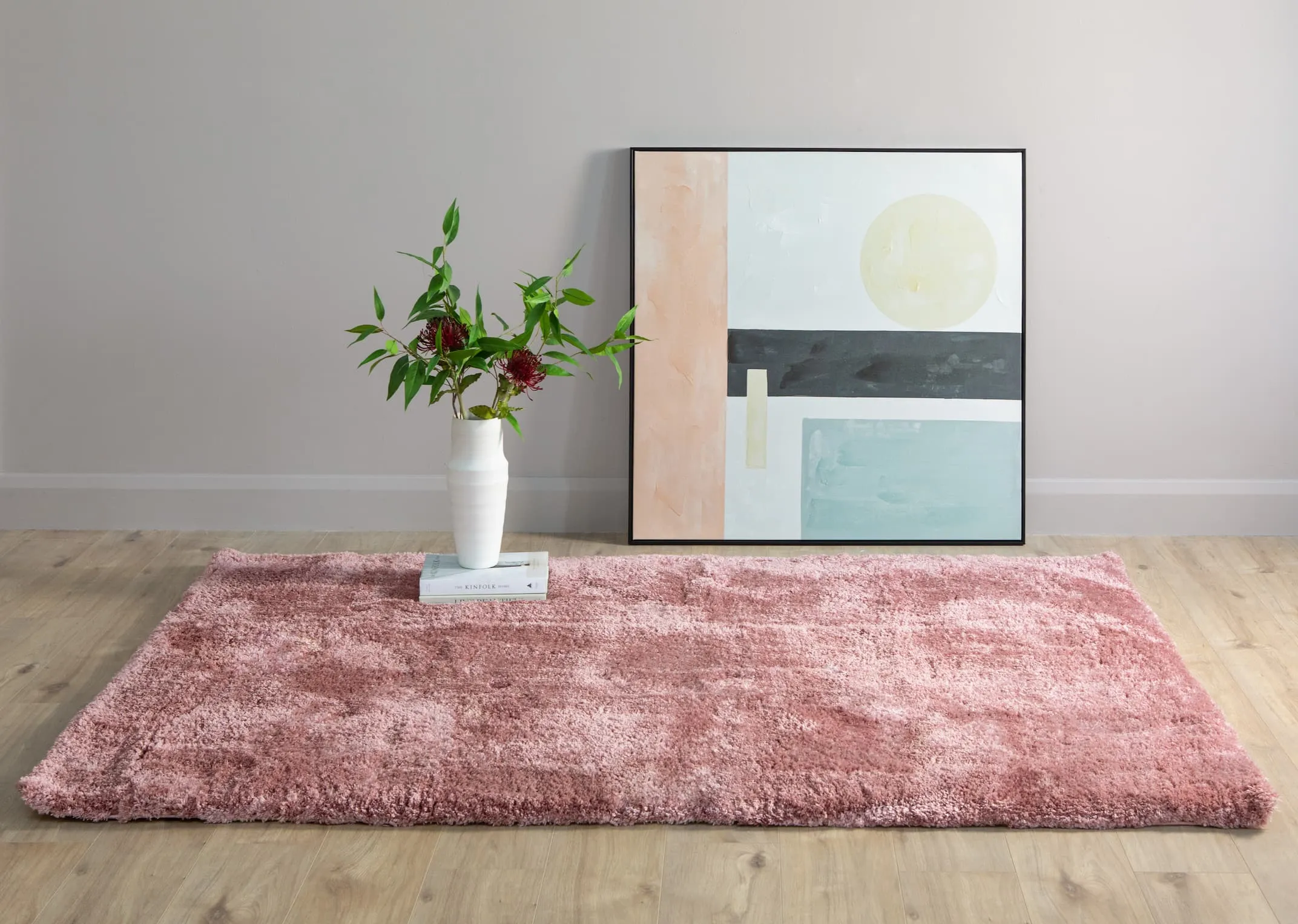 A lifestyle image of the Lux X small coral pink rug with Pastel canvas