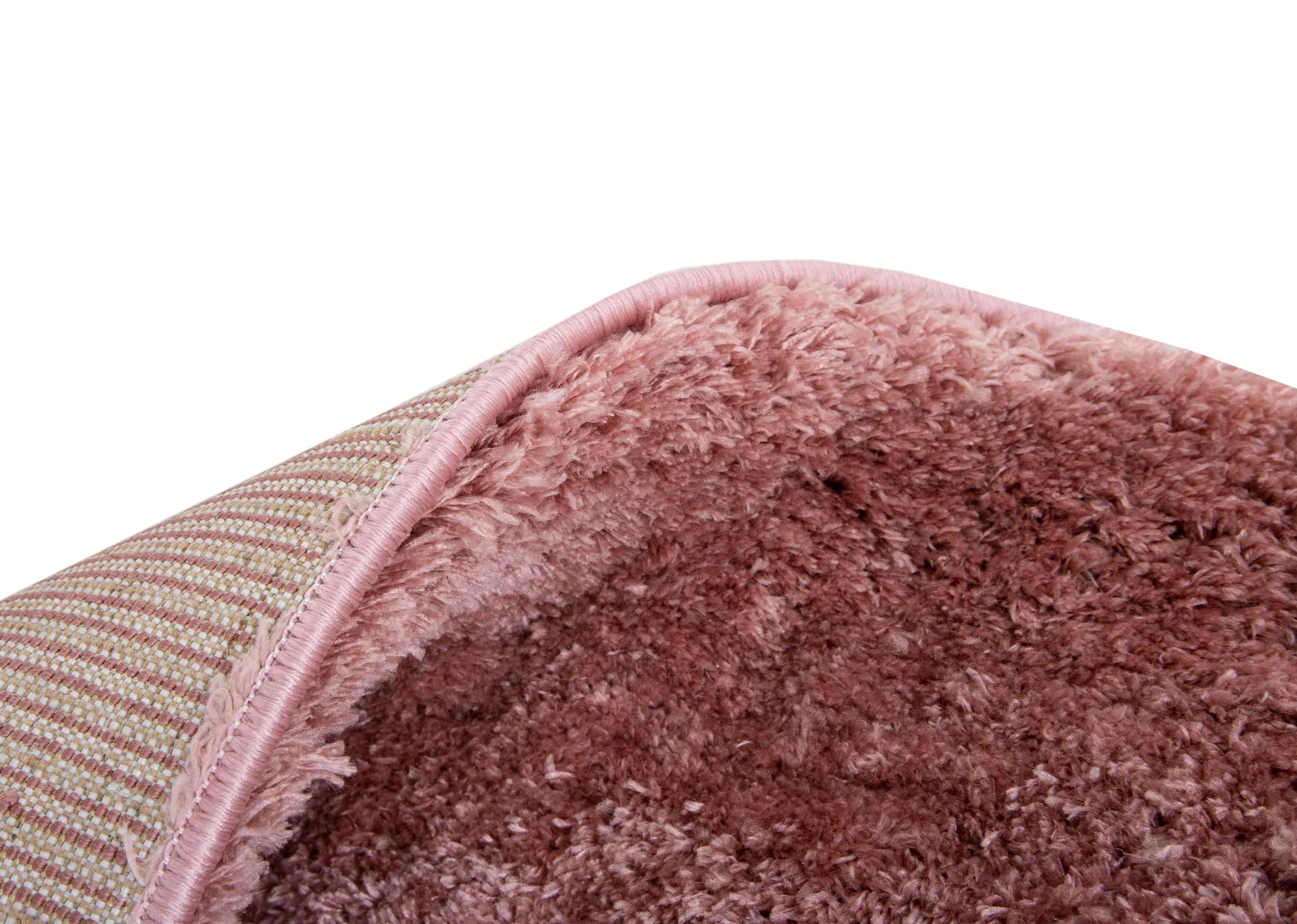 A coral pink deep pile rug from EZ Livings Lux range. Closeup of underlay