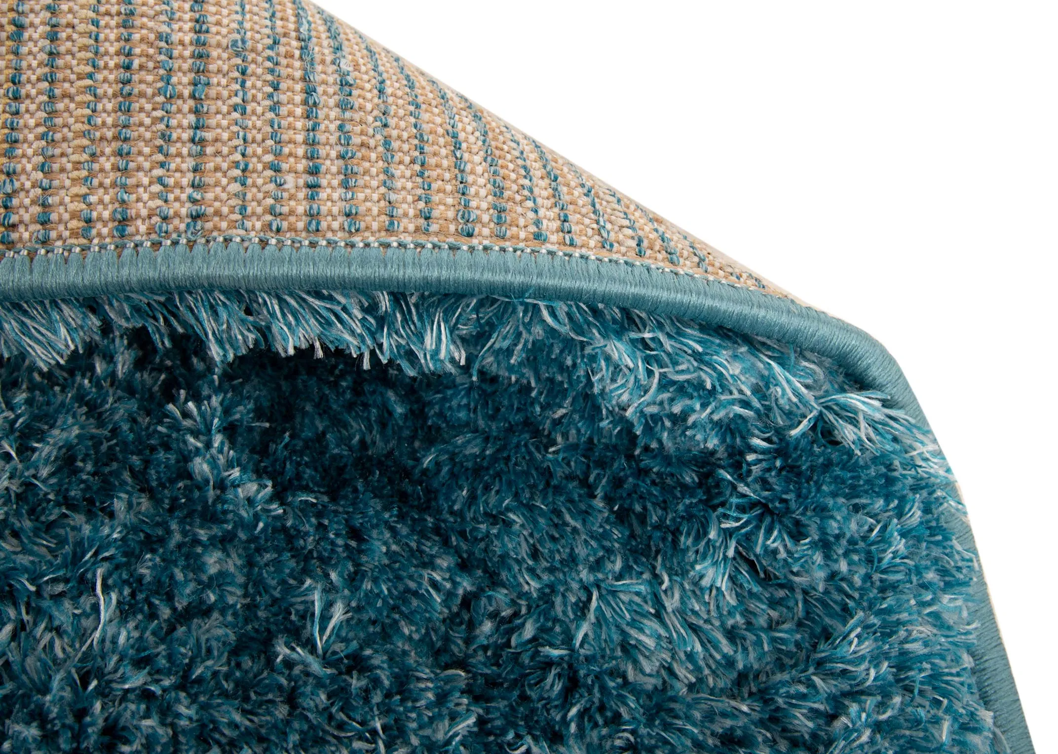 An aqua teal deep pile rug from EZ Livings Lux range. Closeup of underlay