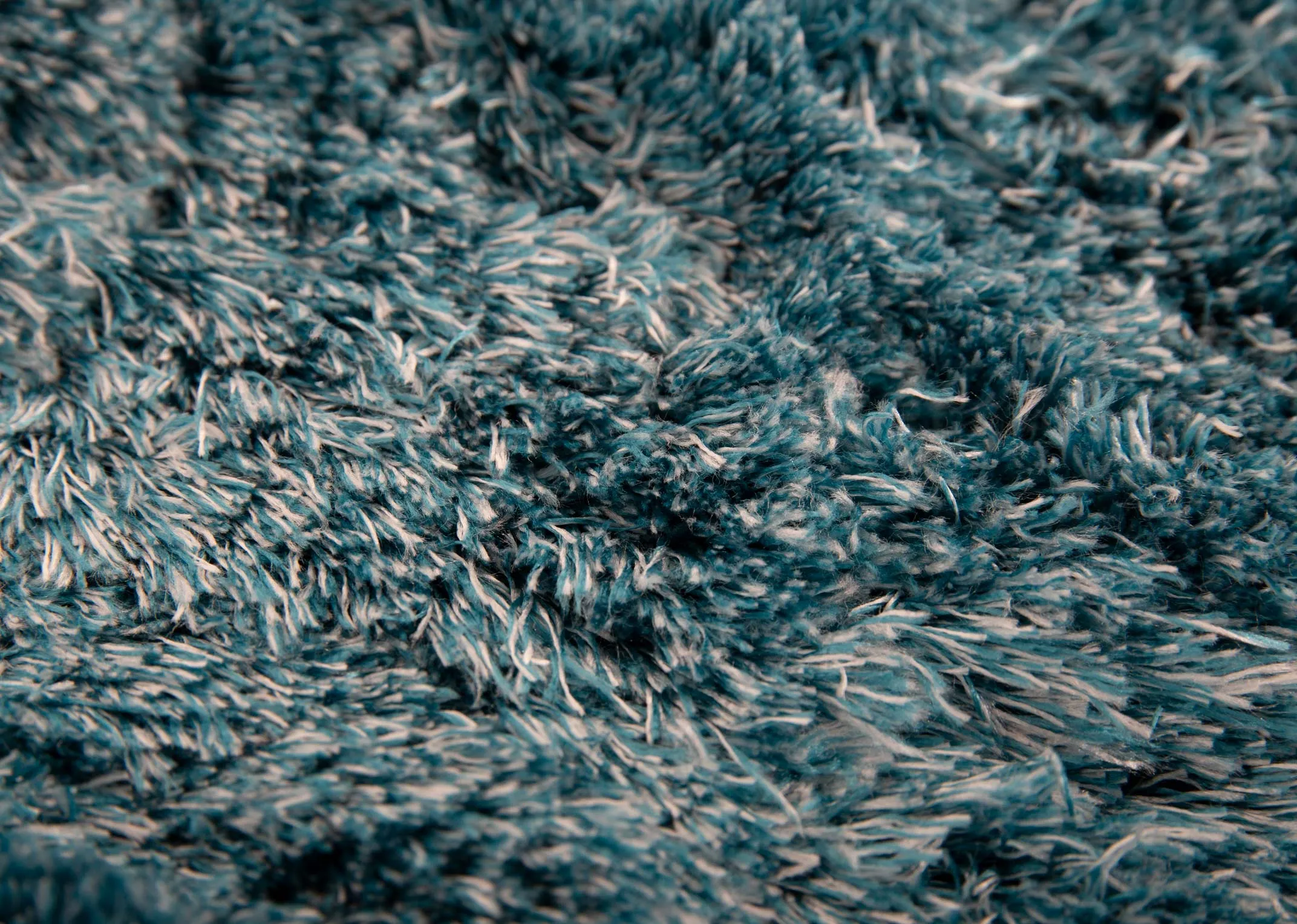 An aqua teal deep pile rug from EZ Livings Lux range. Closeup of fluffy soft to touch texture