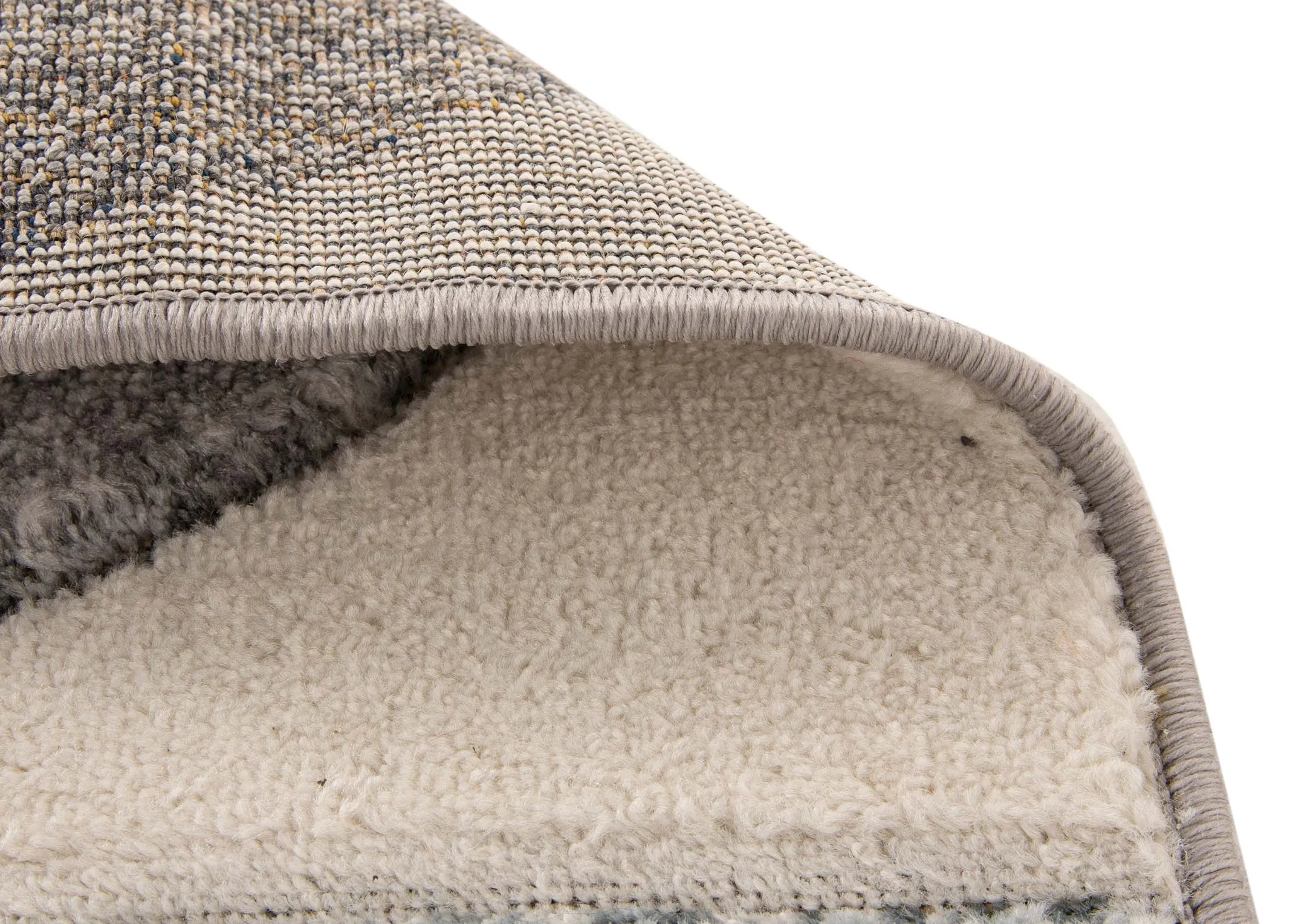 A cream rug with navy and grey quart circle print from EZ Livings Holden range. Closeup of underlay