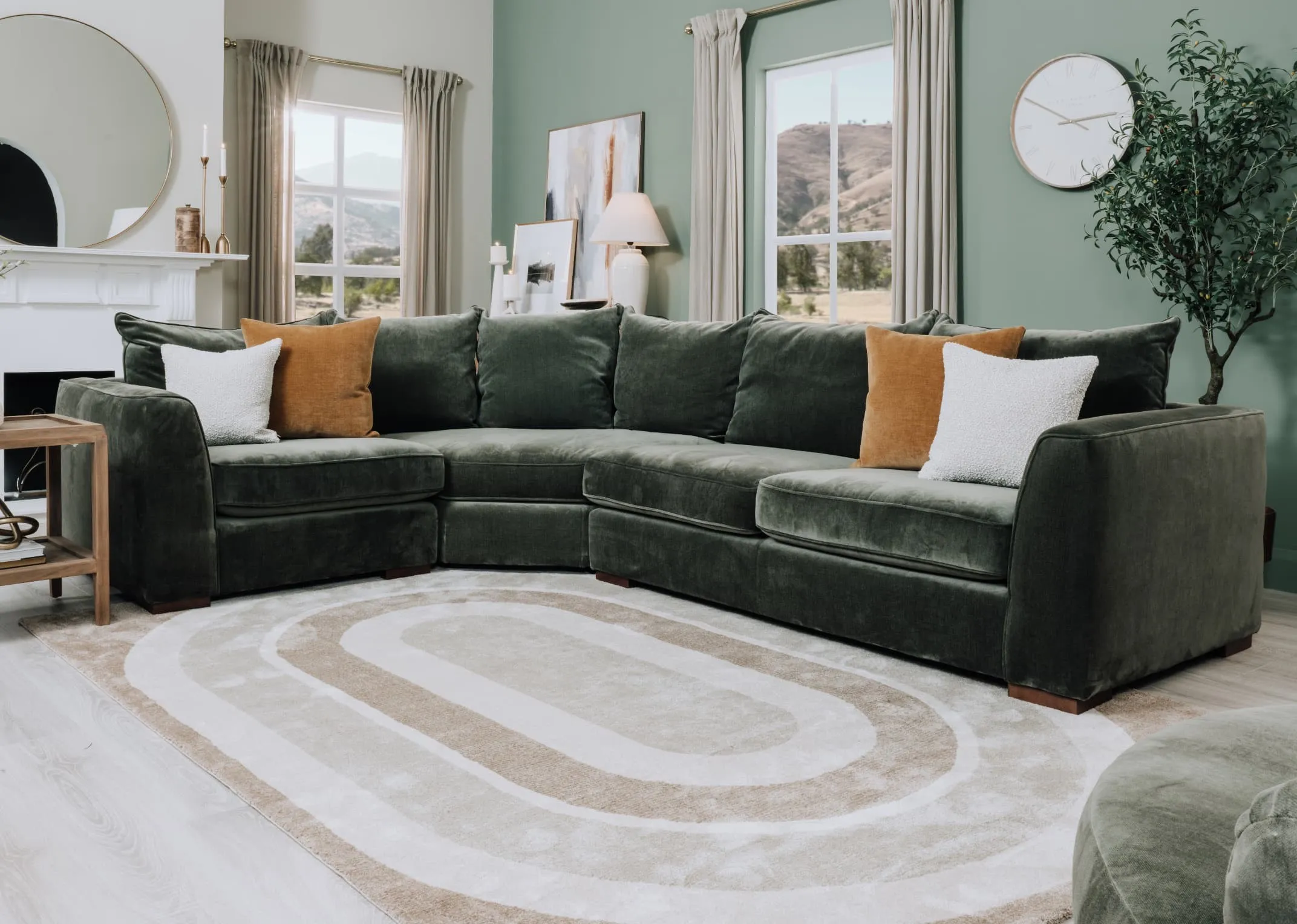 A lifestyle image of the Lucius raf corner sofa with white & gold cushion and delilah rug.