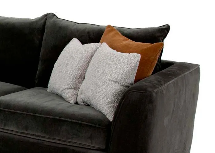 A RAF green fabric corner group from EZ Livings Lucious range. Closeup of green velvet textrue with gold and white textured cushions.