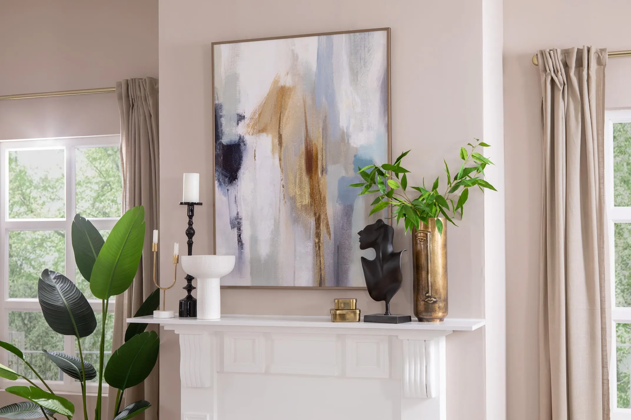 A lifestyle image of the Inspired Canvas over a white fireplace with Lucina dish and Face bust