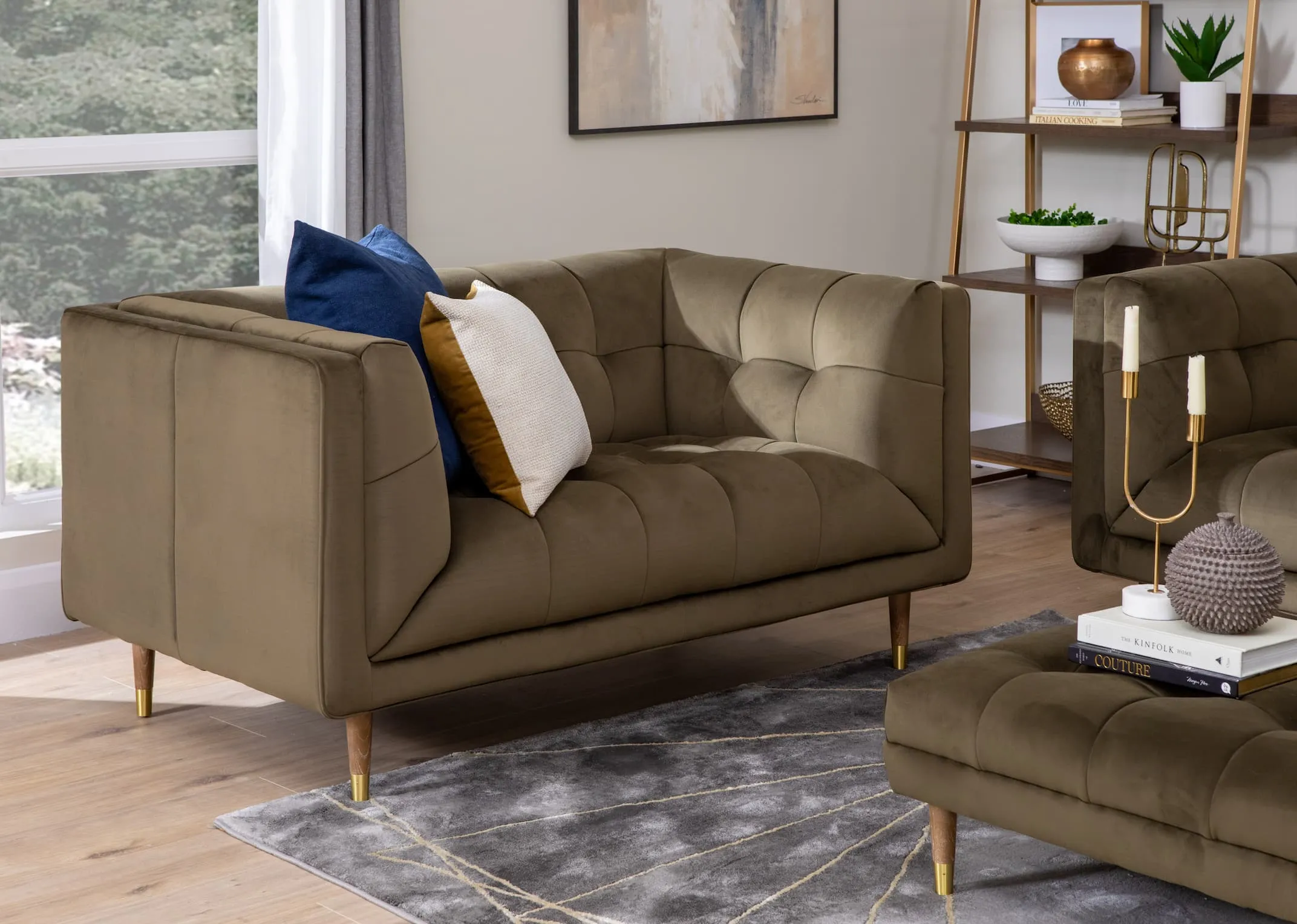 A lifestyle image of the Grace green velvet sofa with footstool & Greenwich bookcase