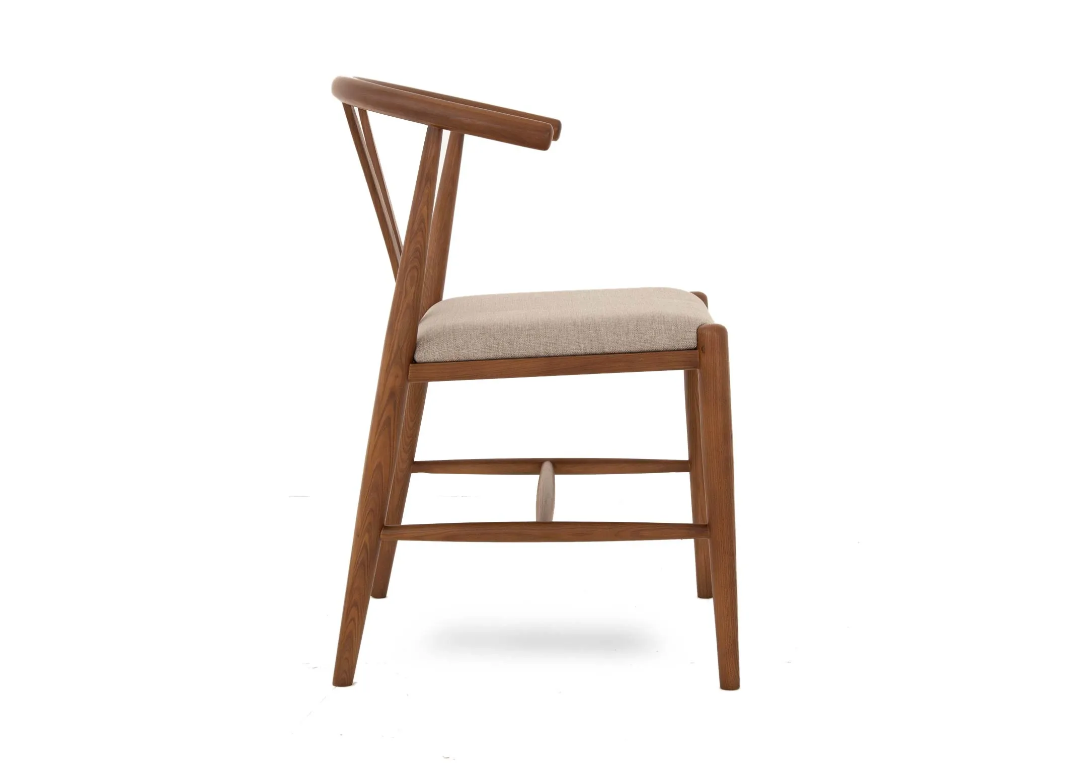 A wishbone dining chair with walnut frame from EZ Livings Cape range. Side view of arched seat top
