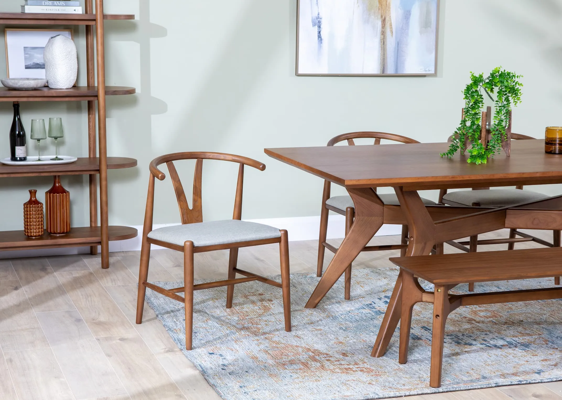 A lifestyle image of the Cape Chairs with the Retro walnut dining table & bench with Maxima rug and Retro display unit.