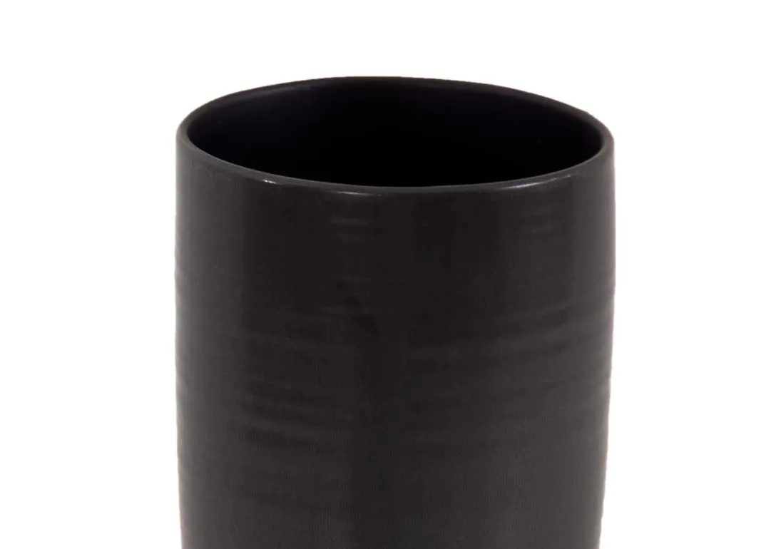 A slim matt black vase with long base from EZ Livings Shalwa range. Closeup of polished texture
