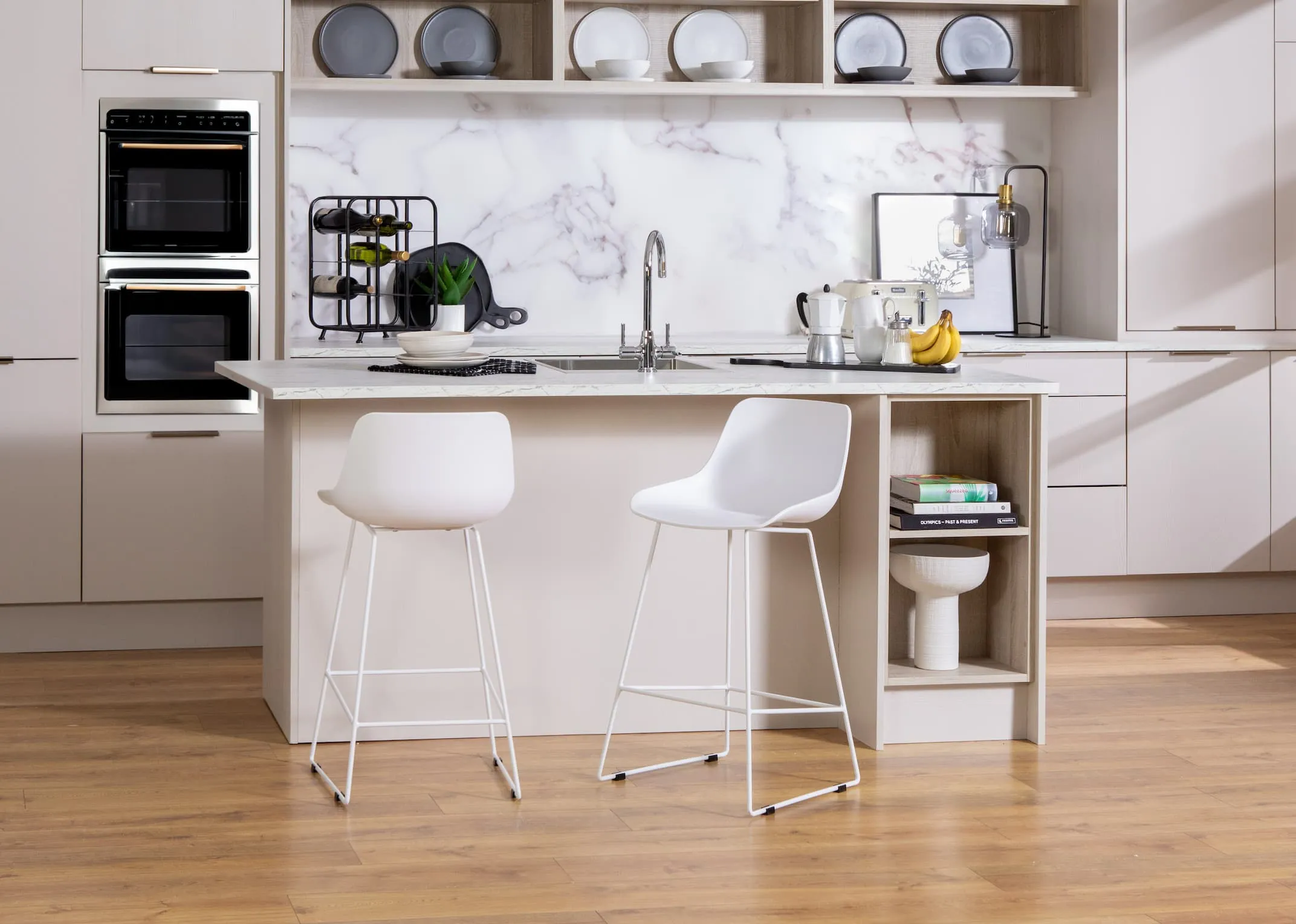 A lifestyle image of the City white counter stools with high back in a kitchen setting at an island.