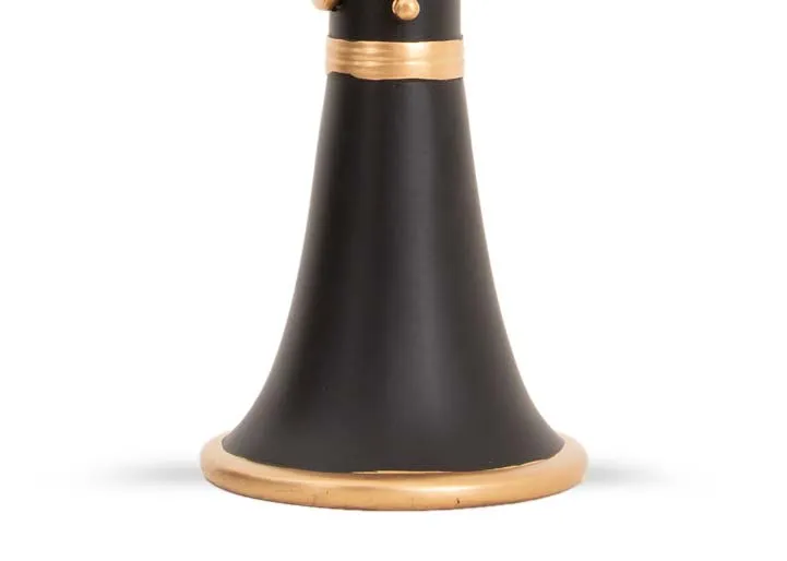 A black & gold Clarinet candleholder from EZ Livings Christmas range. Closeup of wide end base