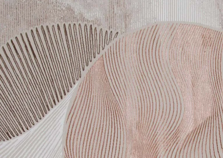 A beige rug with brown cream gold and orange metallic design from EZ Livings Creation range. Closeup of linear color pattern.