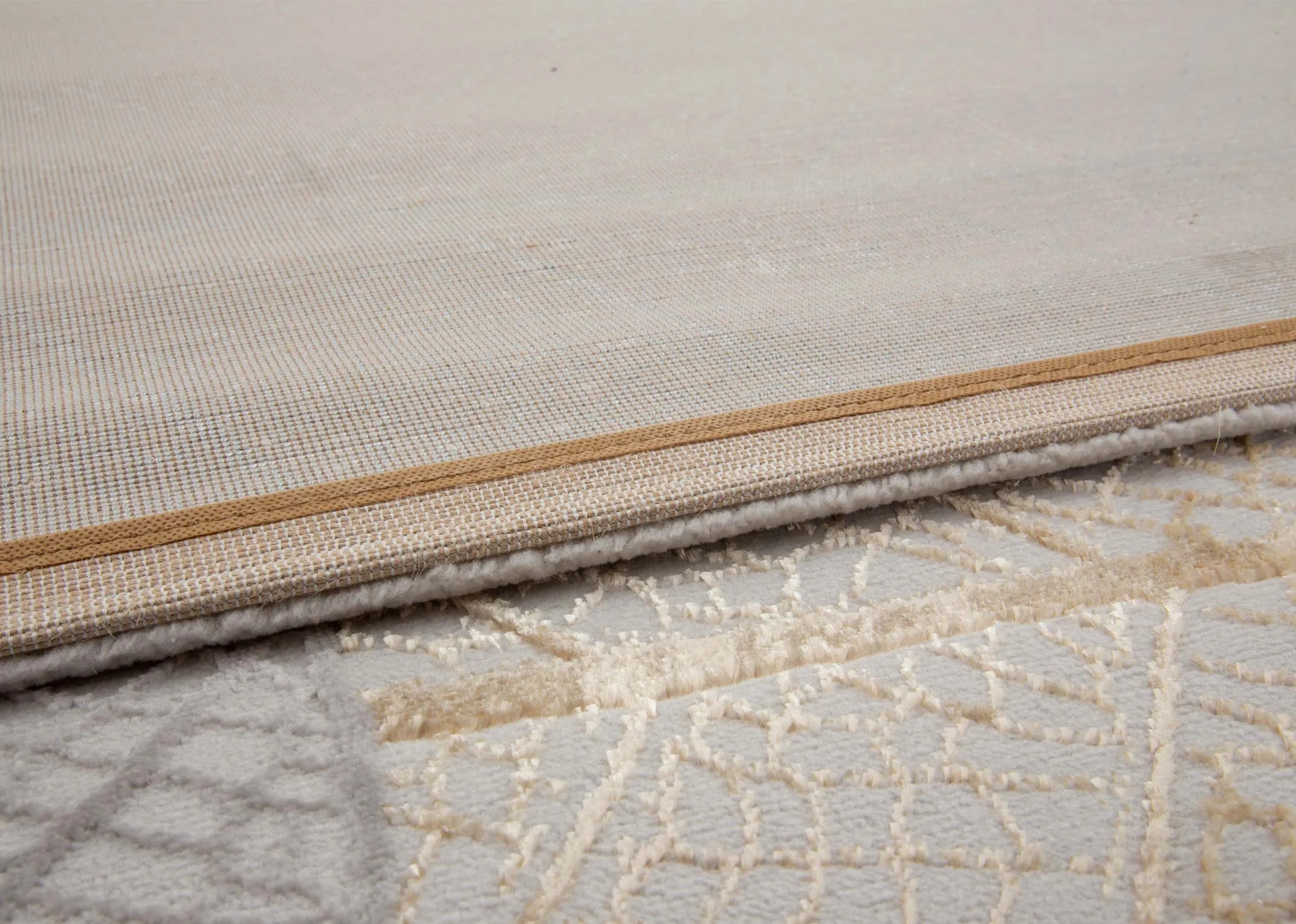 A subtle autumnal leaf print rug from EZ Livings Crete range. Closeup of underlay