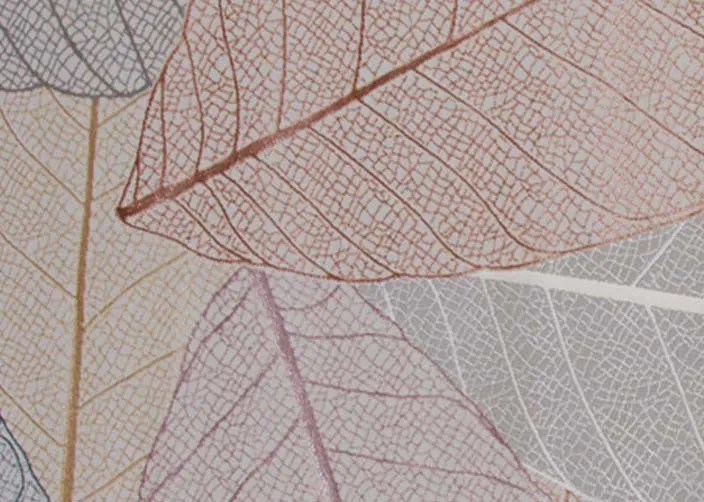 A subtle autumnal leaf print rug from EZ Livings Crete range. Closeup of purple and bronze gold hues.
