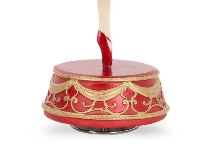 A musical ballerina from EZ Livings Christmas range.Closeup of red & gold musical base