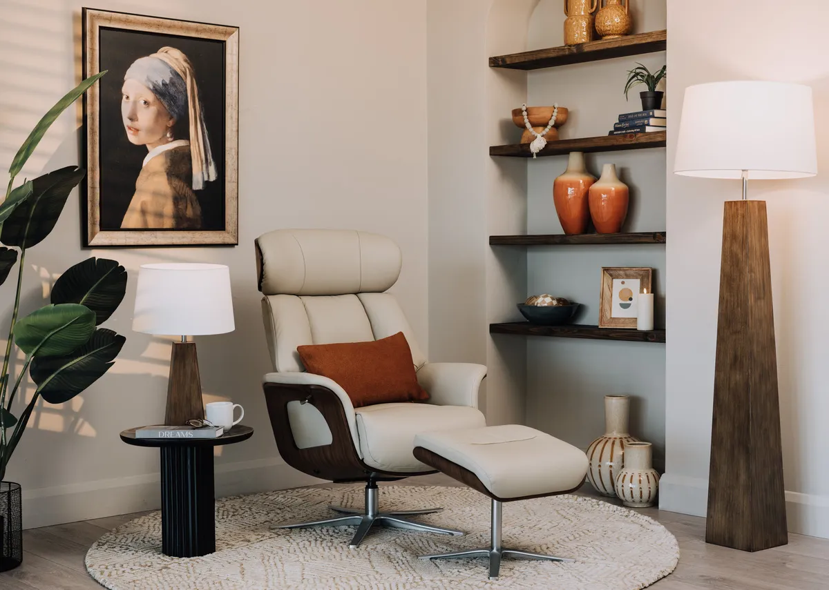 A lifestyle image of the Kendal recliner with Girl with a pearl earring picture and Fauna lamps.