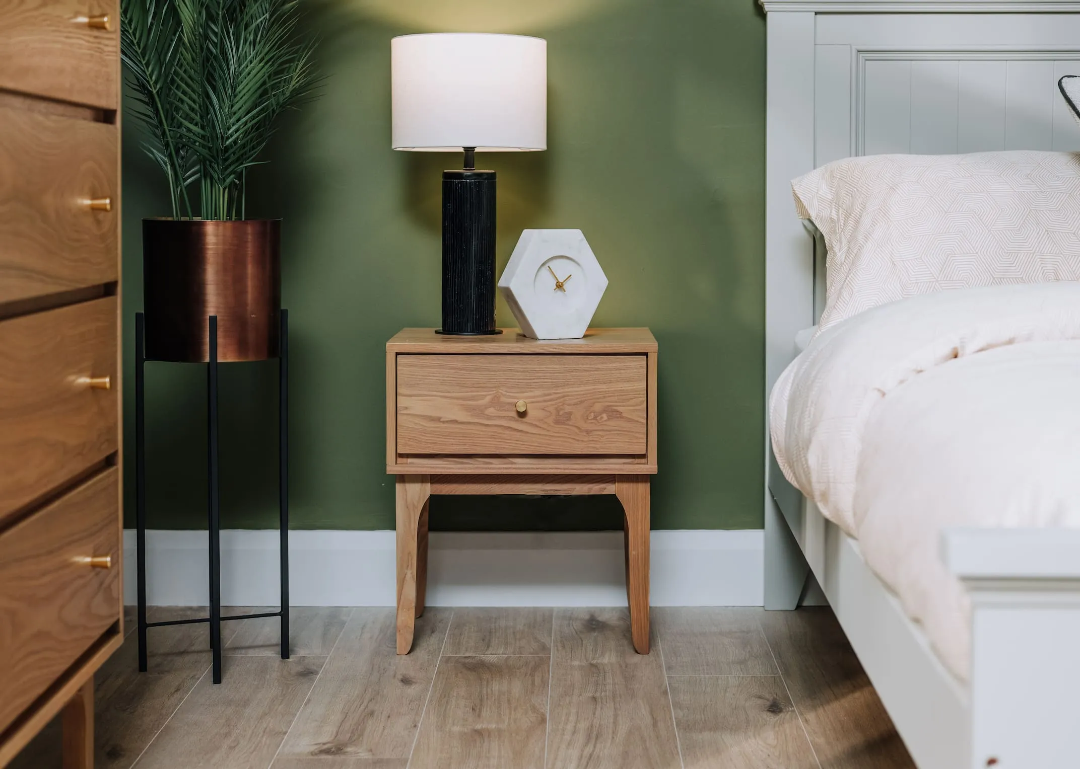 A lifestyle image of the Samuel locker with Lohas table lamp with marble Detina clock.