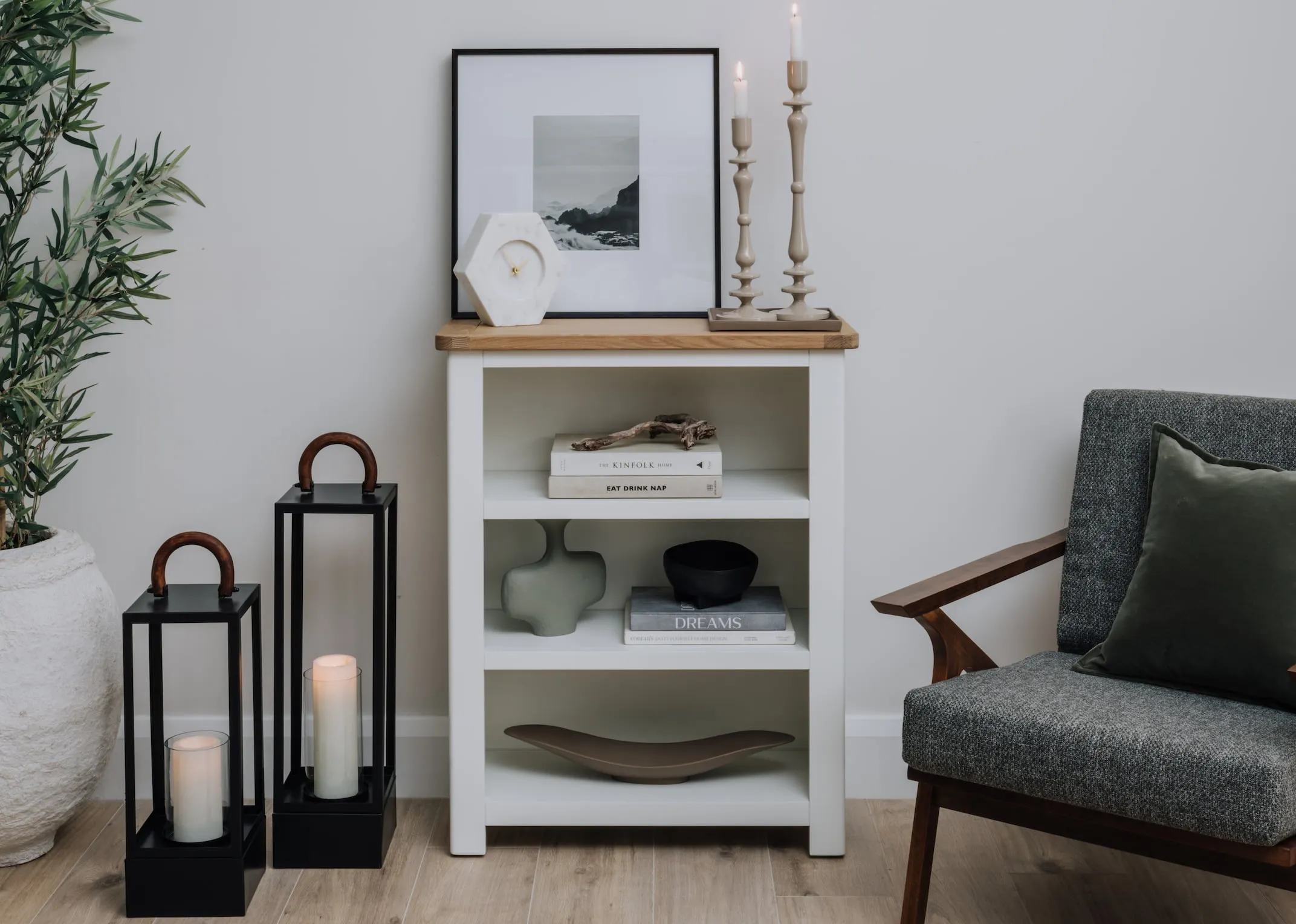 A lifestyle image of the Small Black Lantern with large option beside Barleycove bookcase and Henry chair.