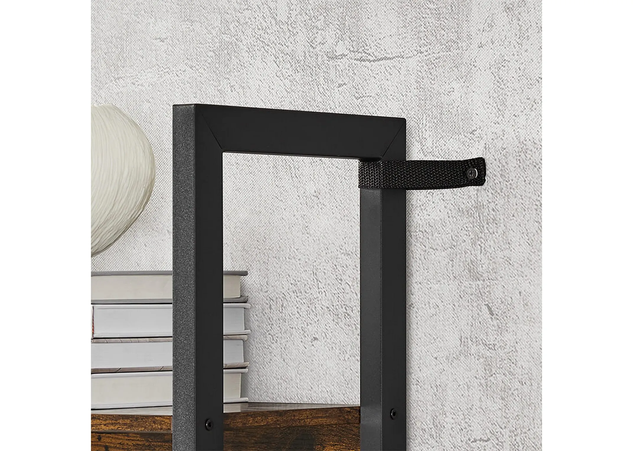 A black framed stand with 2 duplicate wood shelf units on either side of a 4 tier display unit from EZ Livings Bourbon range. Closeup of black straps that attache shelving unit to walls