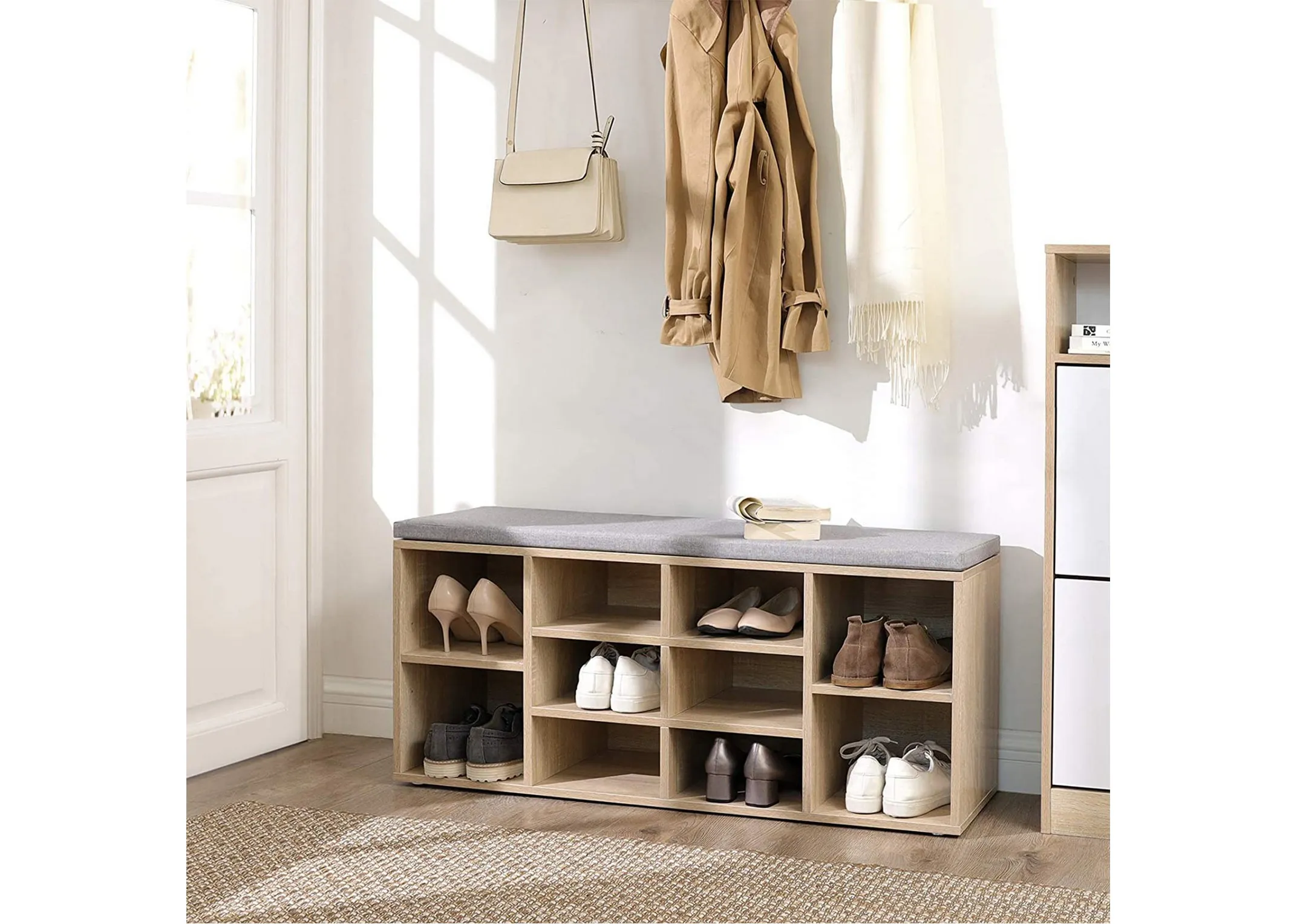 A lifestyle image of the Jojo storage bench in use as a shoe and hallway tidy inside a front door of a home.