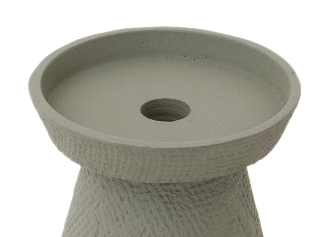 A green pillar candle holder from EZ Livings deco range. Closeup of holder for pillar candle.