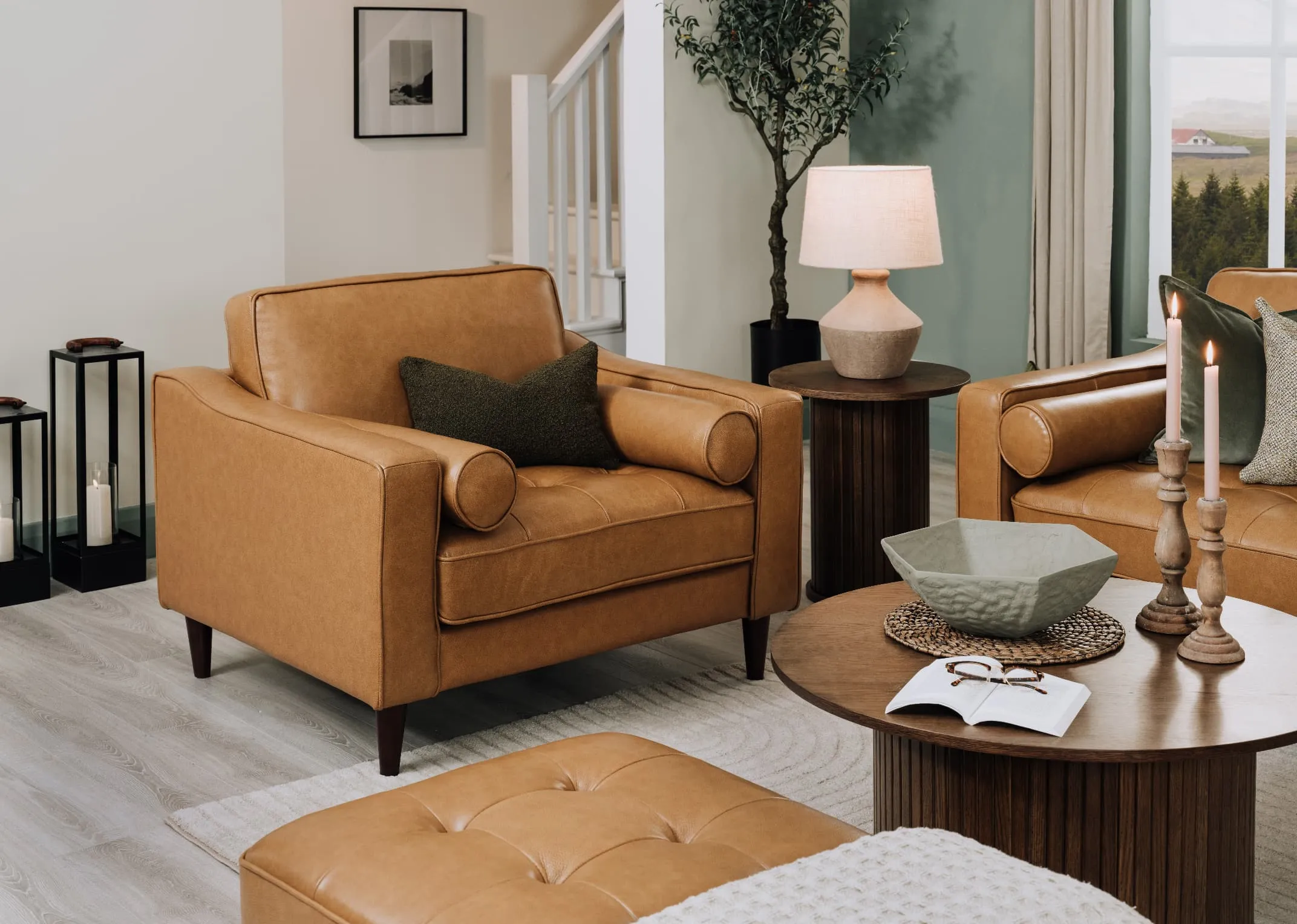 A lifetsyle image of the Genoa armchair with benbulbin cushion with Nola coffee table with Large Green bowl.