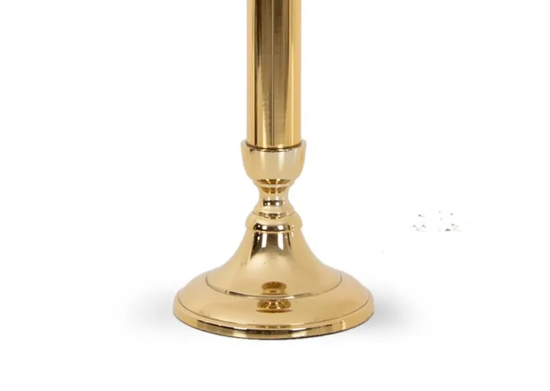 A gold stand with glass pillar candle holder from EZ Livings Christmas range. Closeup of gold metal stand