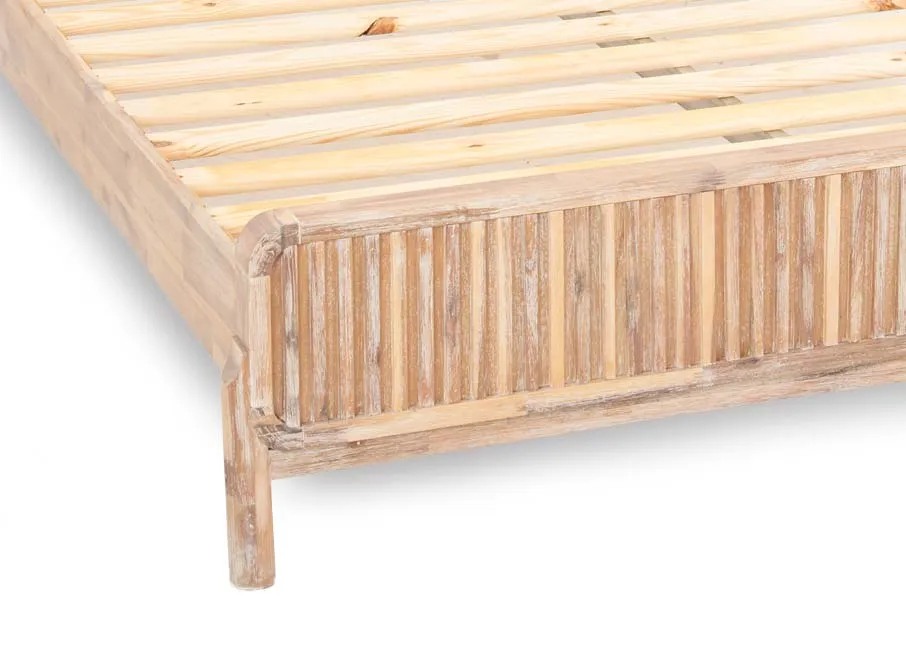 A double 4ft 6 acacia bedframe from EZ Livings Milo range. Closeup of distressed finish on footboard.