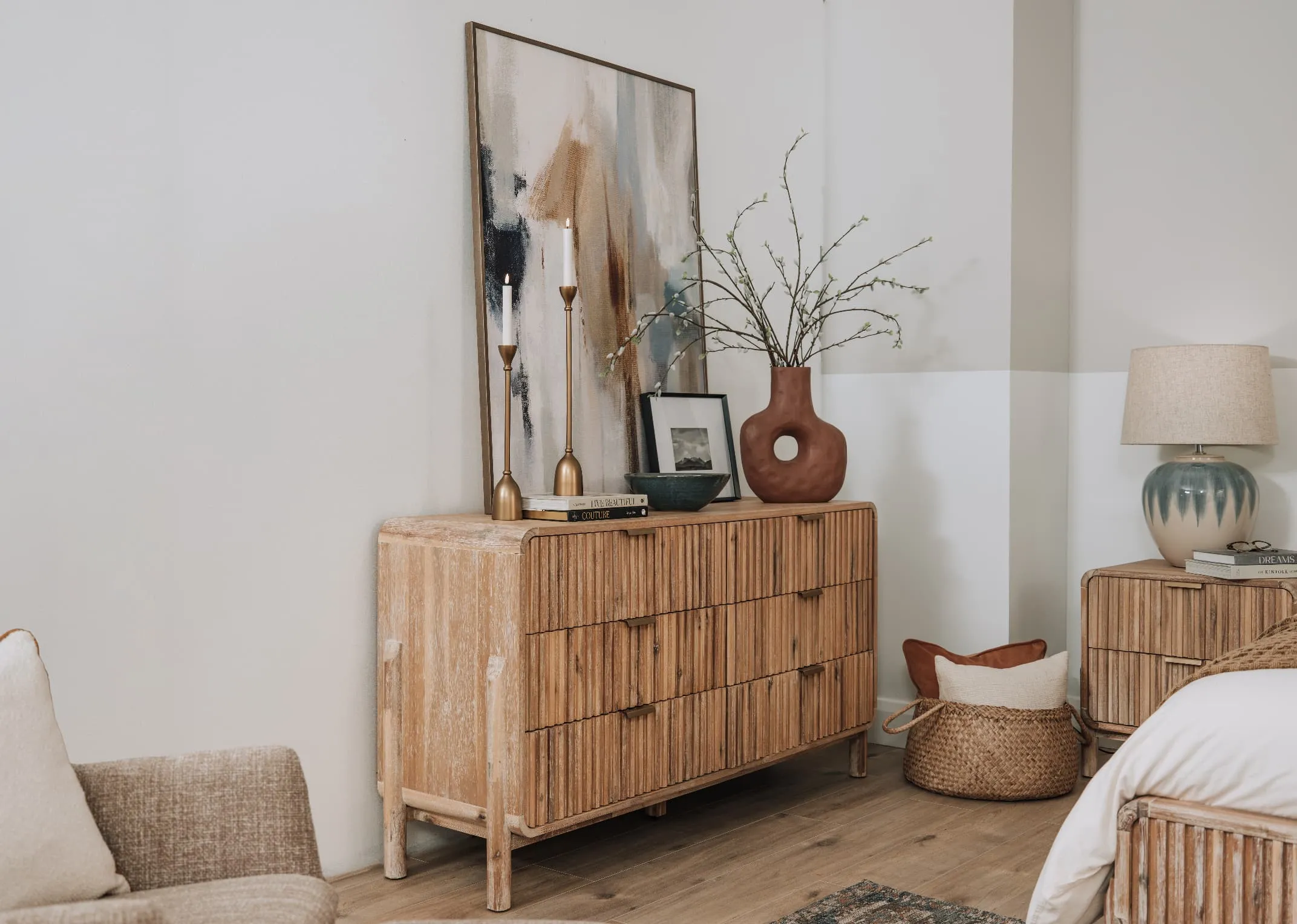 A lifestyle image of the Milo dresser with Inspire canvas and serla candleholders with Terracotta vase.