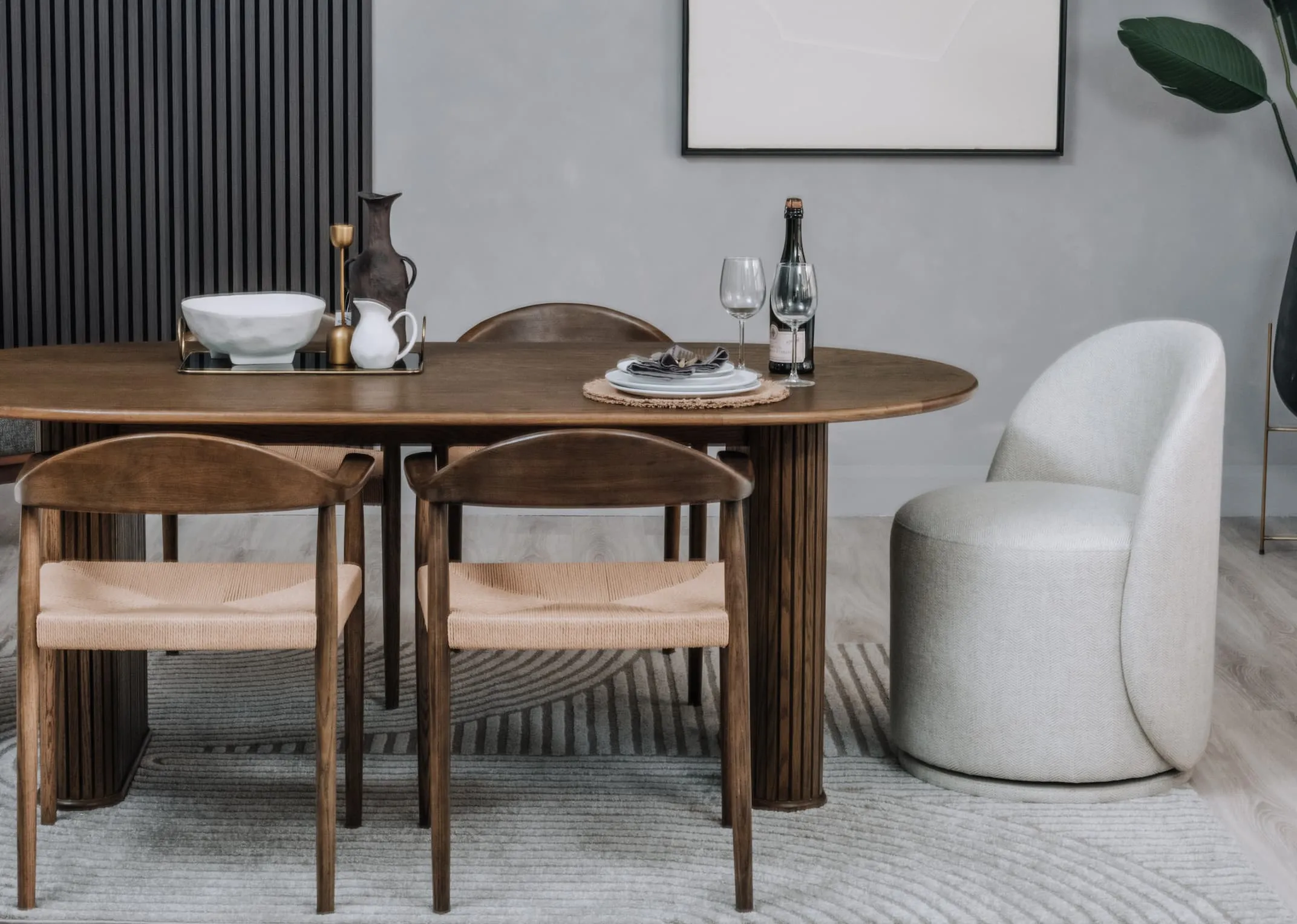 A lifestyle image of the Marion swivel chair with Tambour dining table and wave chairs.