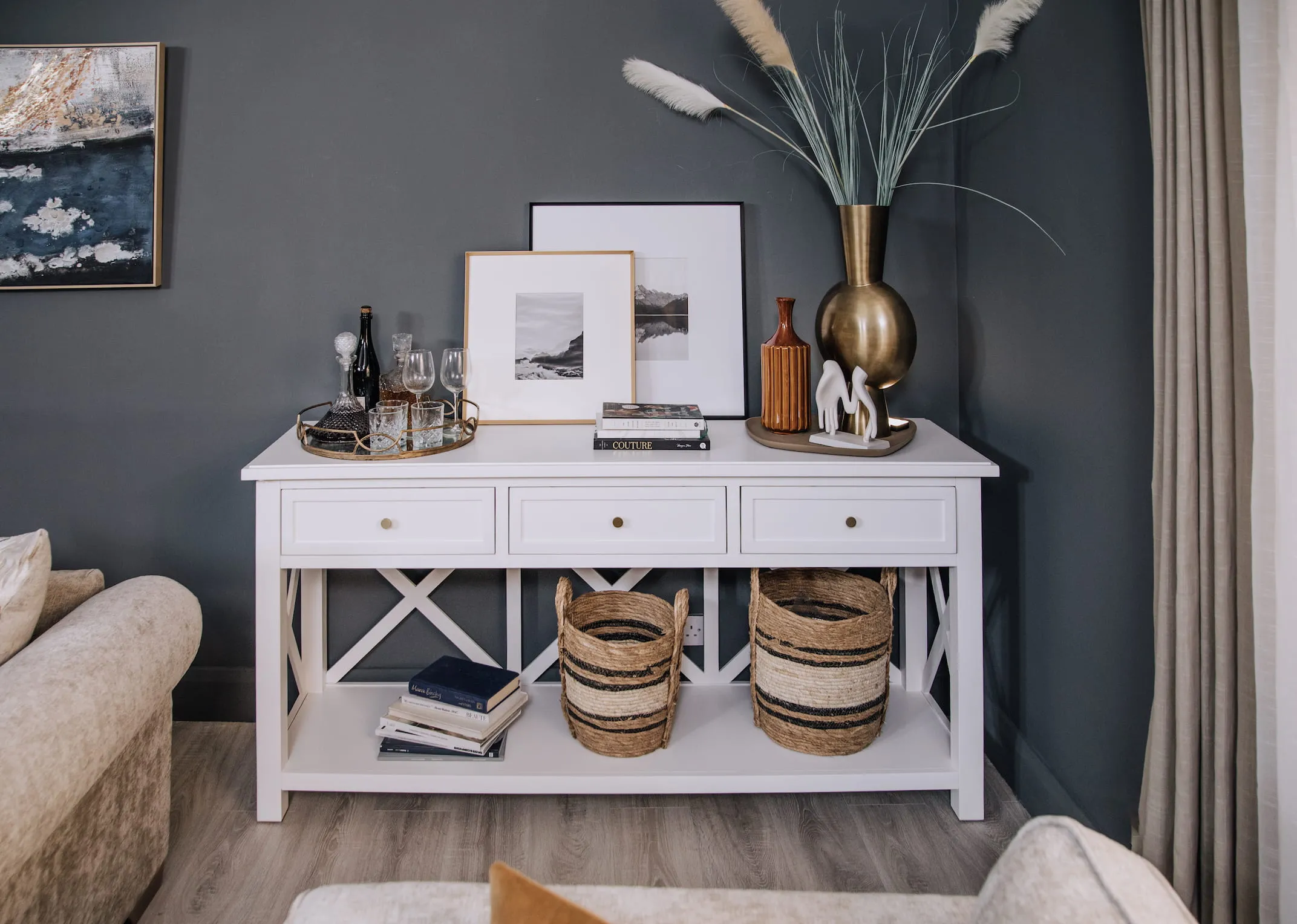 A lifestyle image of the Hampton Console Table with a selection of vases