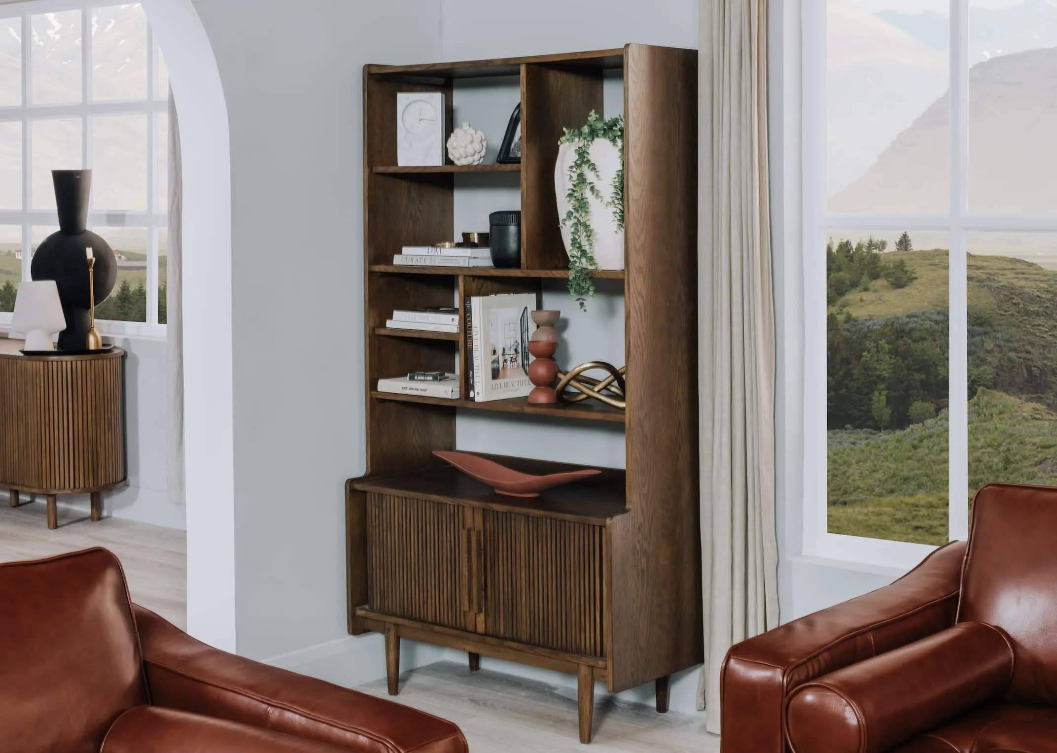 A lifestyle image of the Delano Bookcase with accessories and books with Genoa sofas from EZ Living.