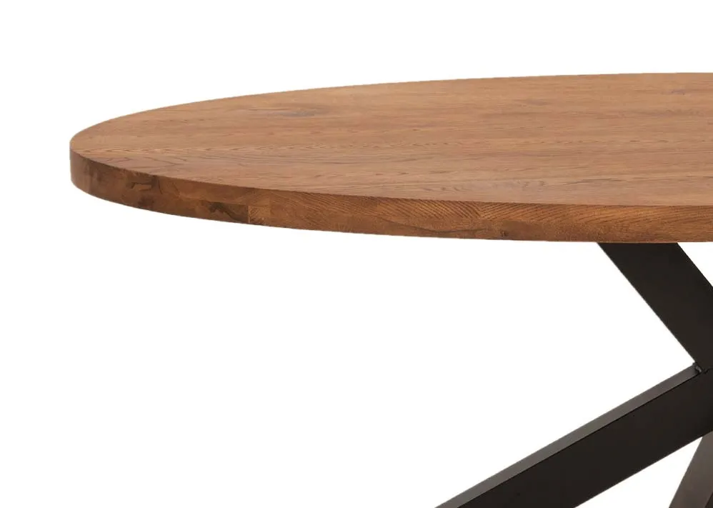 An oval oak dining table with black x legs from EZ Living Furniture's Oslo range. Closeup of chestnut veneers