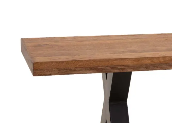 A chestnut oak dining bench with metal x base from EZ Livings Davos range. Closeup of thick wood top