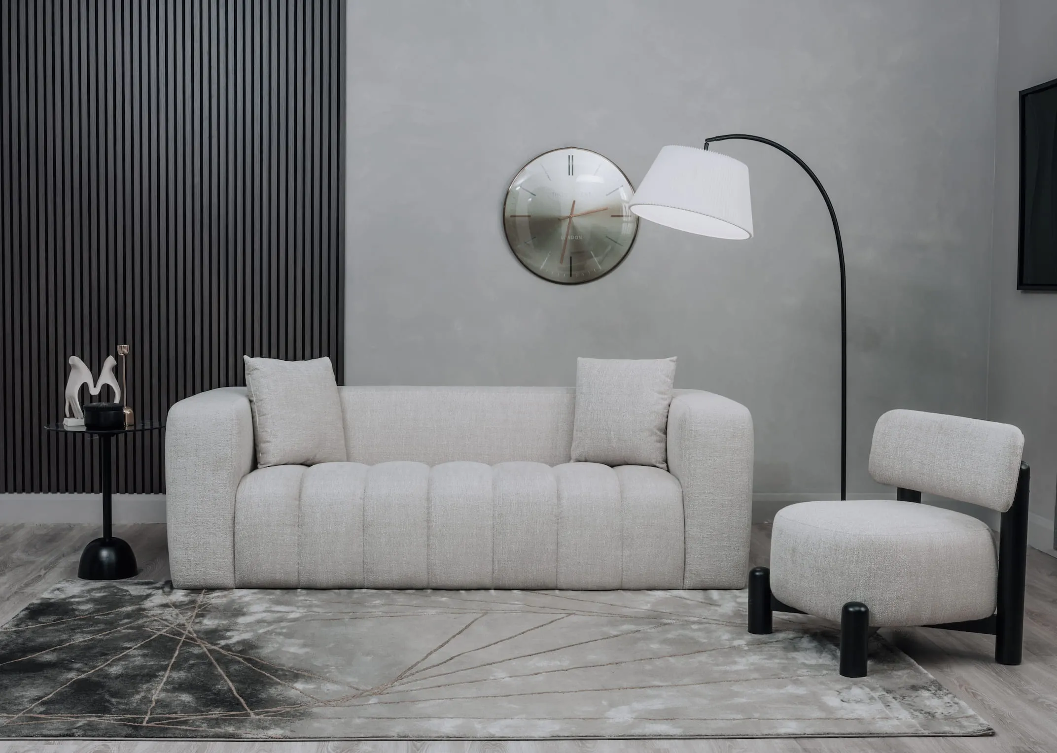 A lifestyle image of the Brandon sofa & Ember chair with Black acoustic panels on wall.