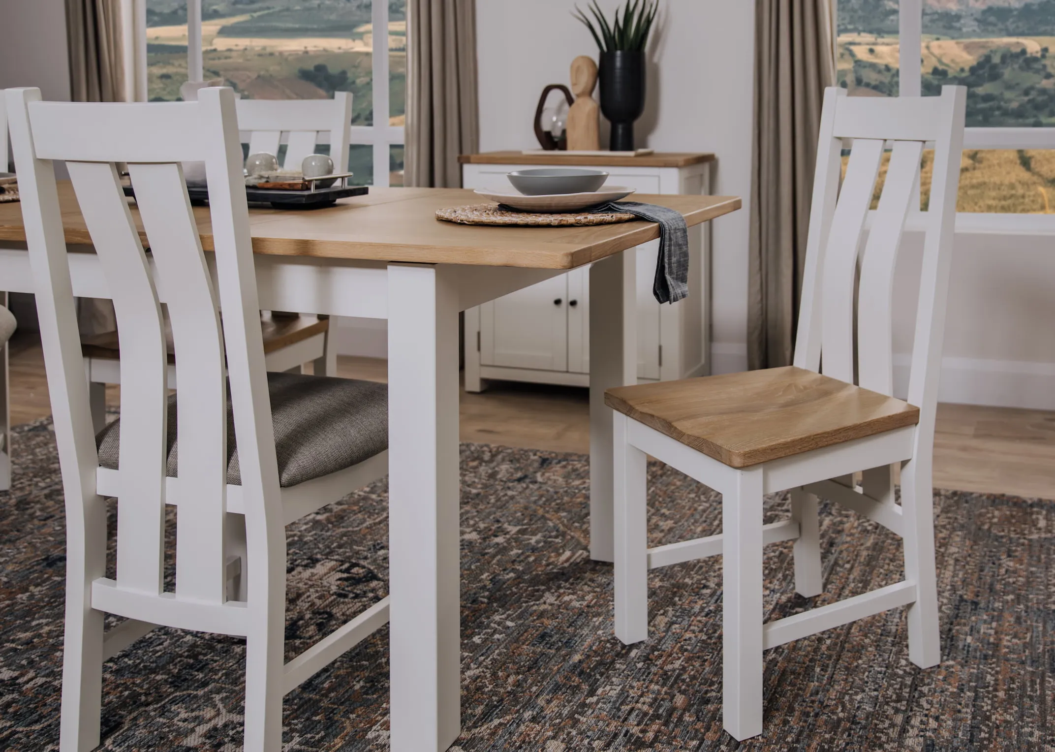 A lifestyle image of the Barleycove wooden chair with dining table and sideboard.