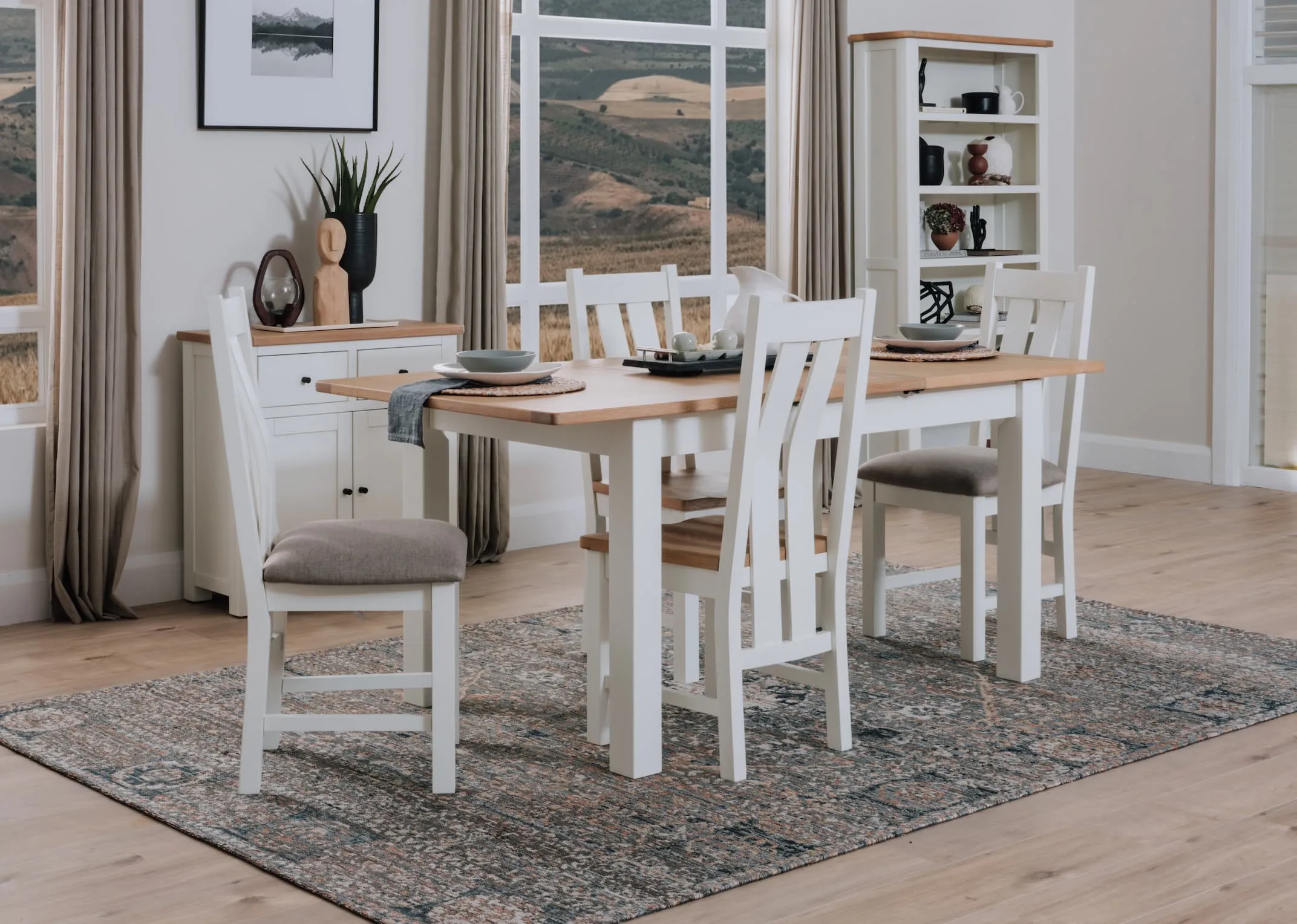 A lifestyle image of the Barleycove dining table & chairs with sideboard and bookcase.