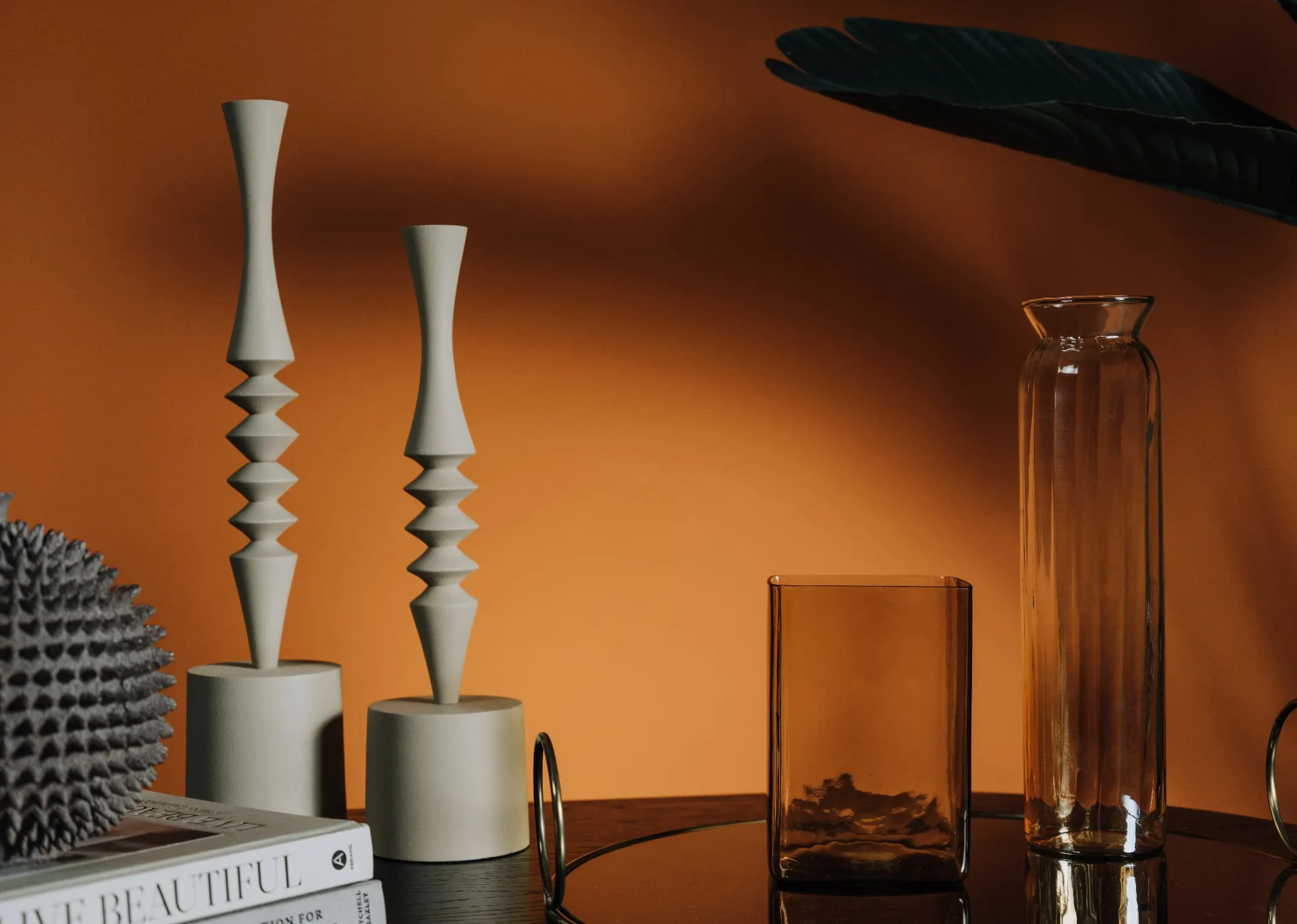 A lifestyle image of the Mistry Candleholders with Lustre Vases.