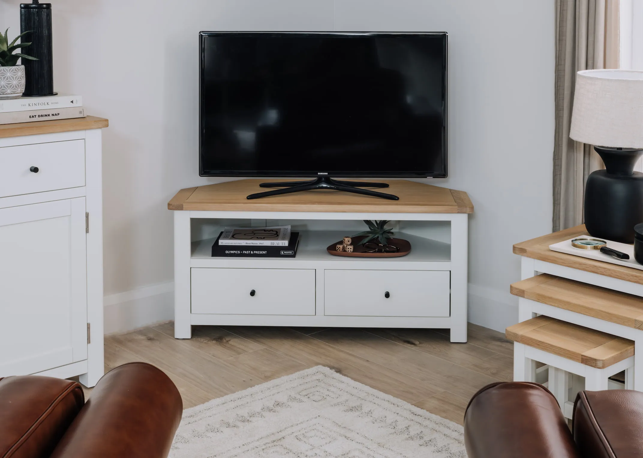 A lifestyle image of the Barleycove tv stand with flatscreen and matching nests.