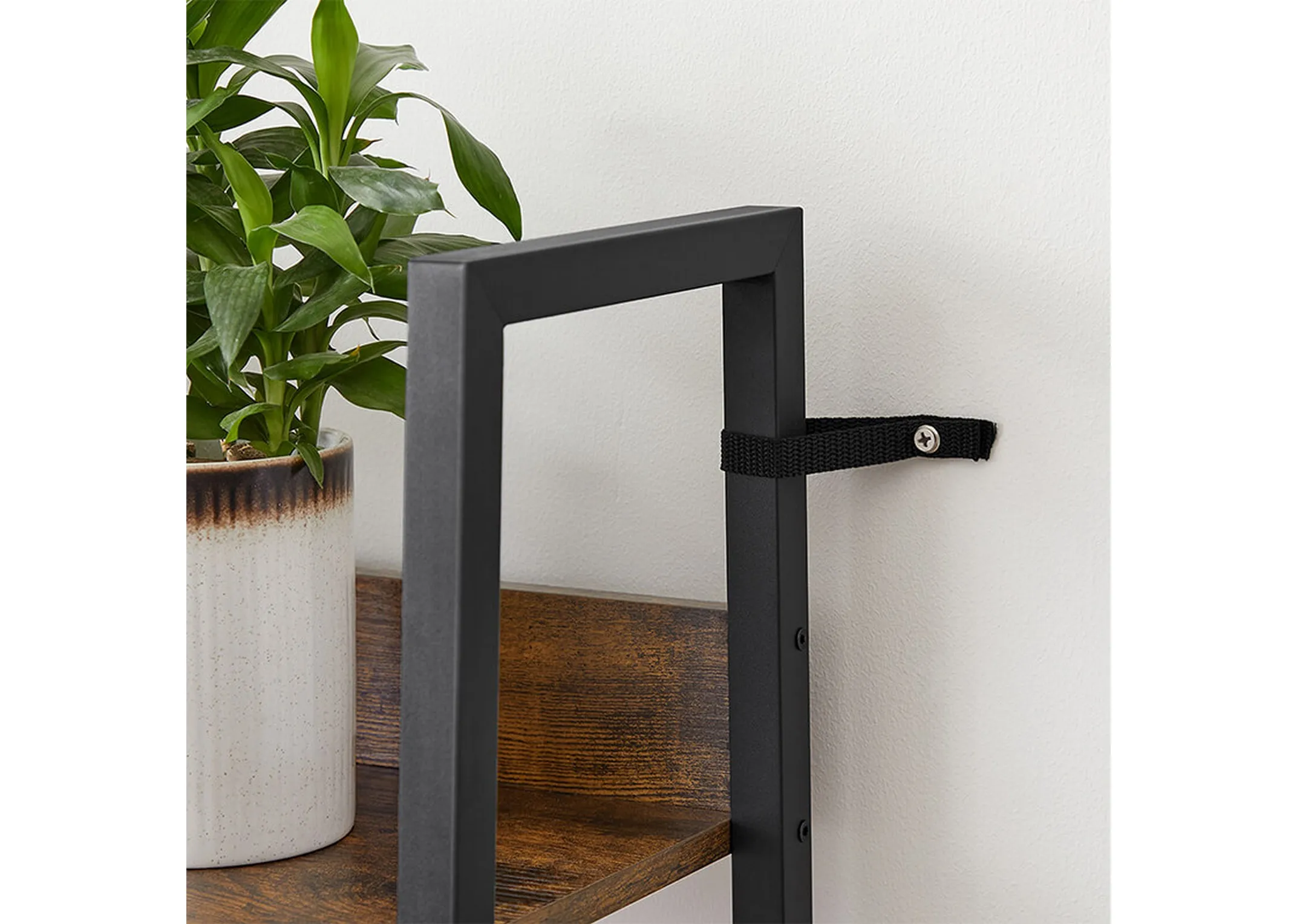 A metal ladder frame with 5 rustic brown shelves from EZ Livings Specter range. Closeup of feet