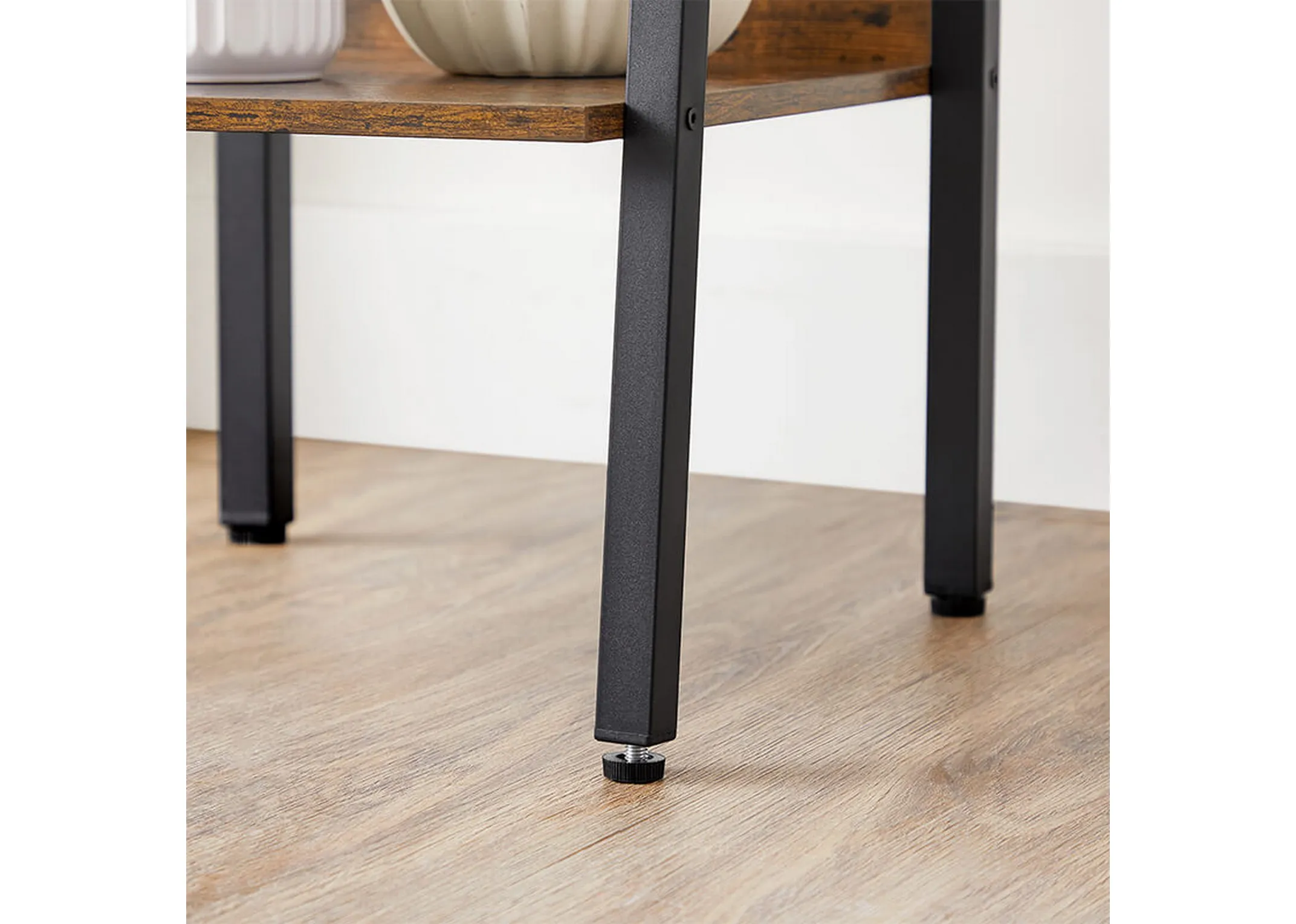 A metal ladder frame with 5 rustic brown shelves from EZ Livings Specter range. Closeup of supportive wood shelves